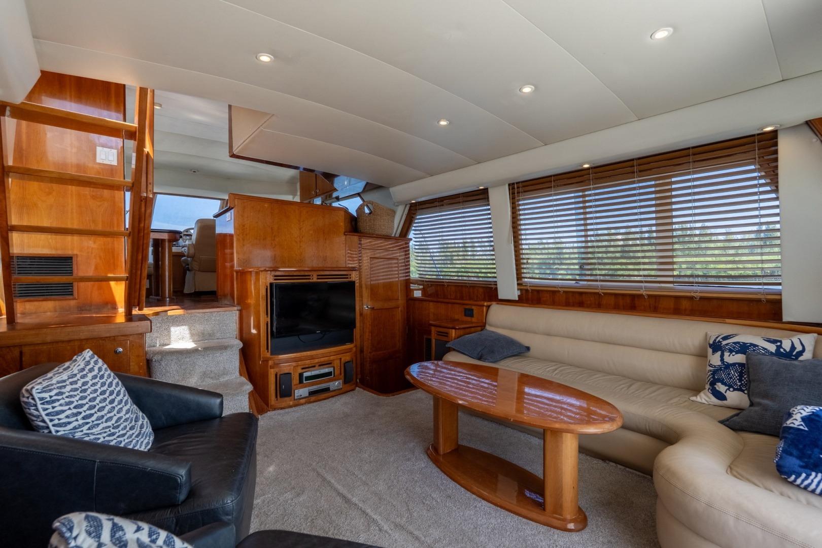 Luxurious 2003 Navigator 5700 yacht interior with plush seating and elegant wood finishes.
