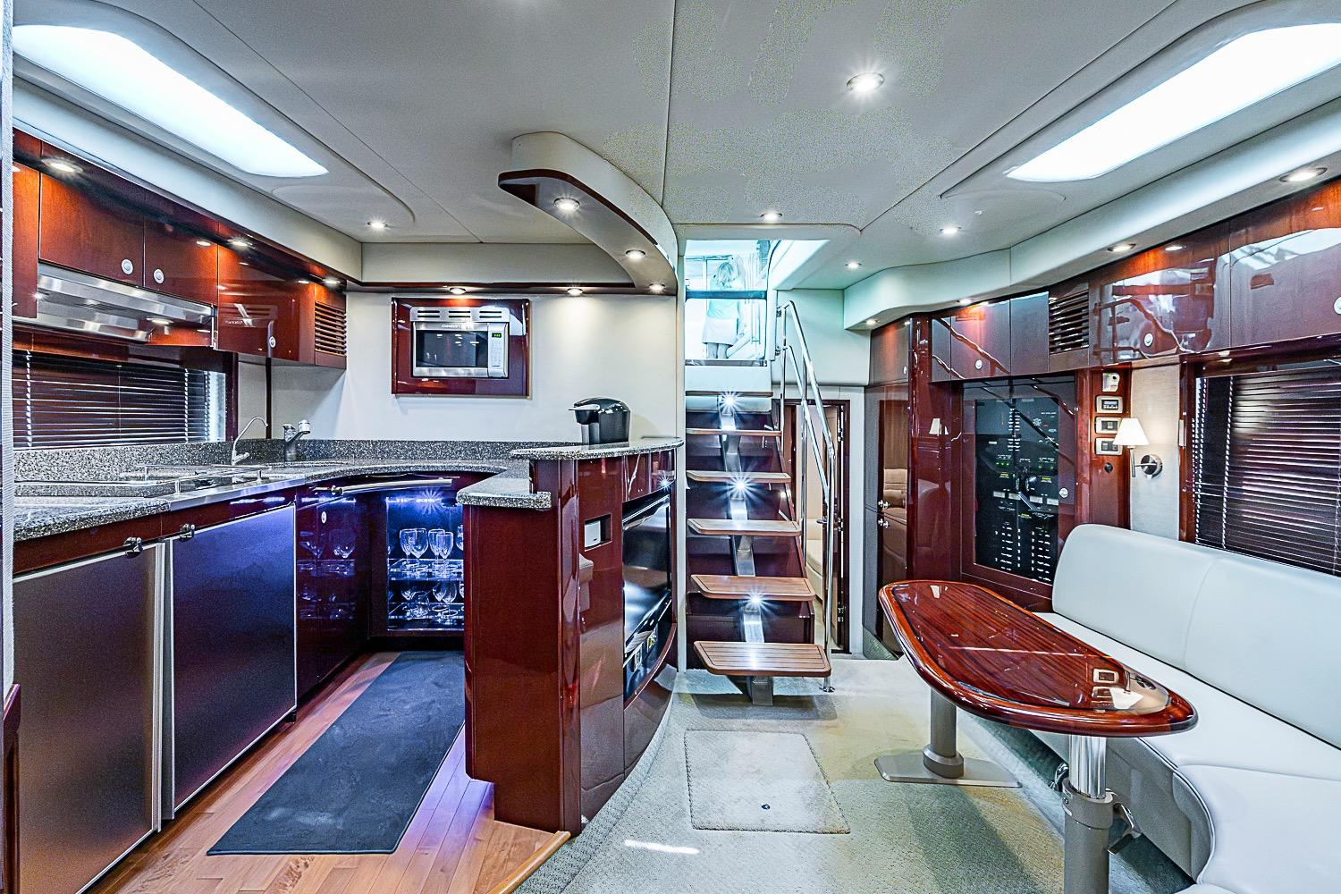 Luxurious interior of a 2008 Sea Ray 60 Sundancer yacht with modern kitchen and seating area.