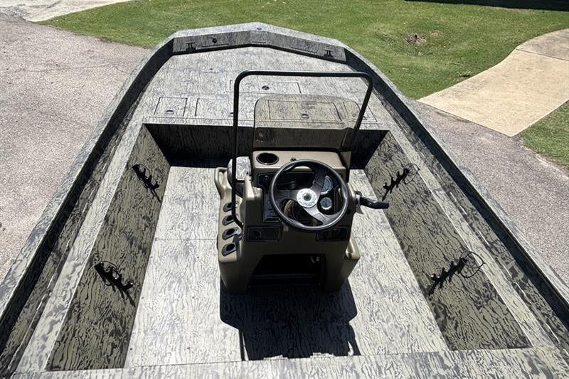 2026 Tracker Grizzly 2072 CC boat interior with steering console and rod holders.