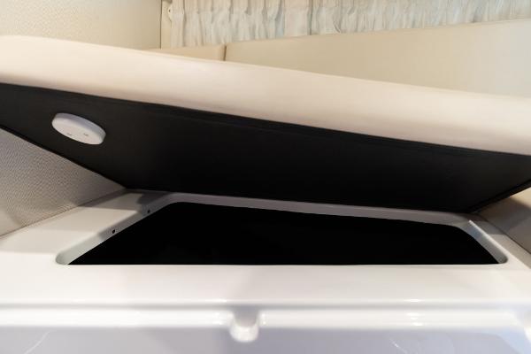 2016 Regal 28 Express boat interior storage compartment with open lid.