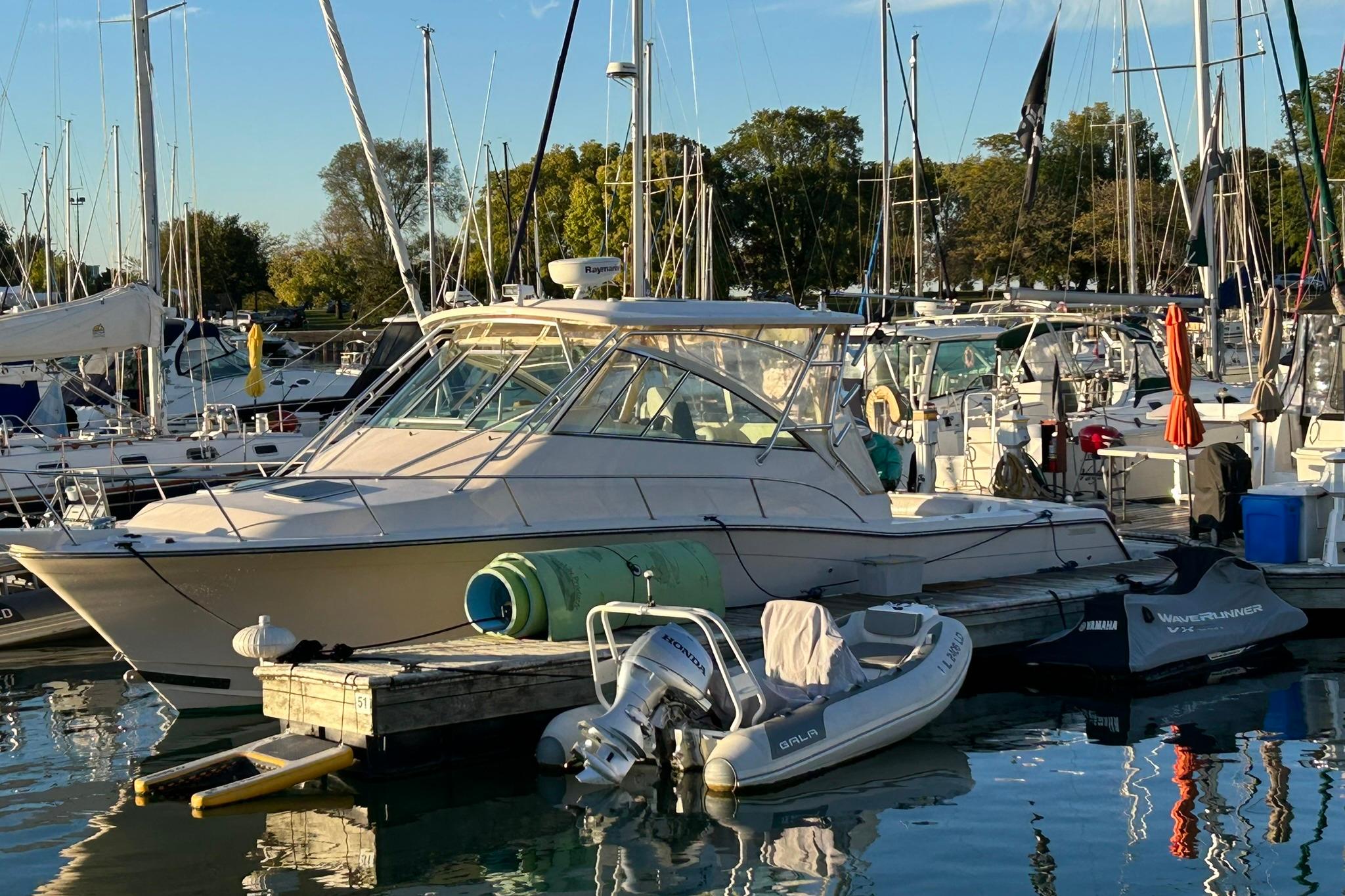 2007 Grady-White Express 360 boat docked at marina with surrounding vessels.