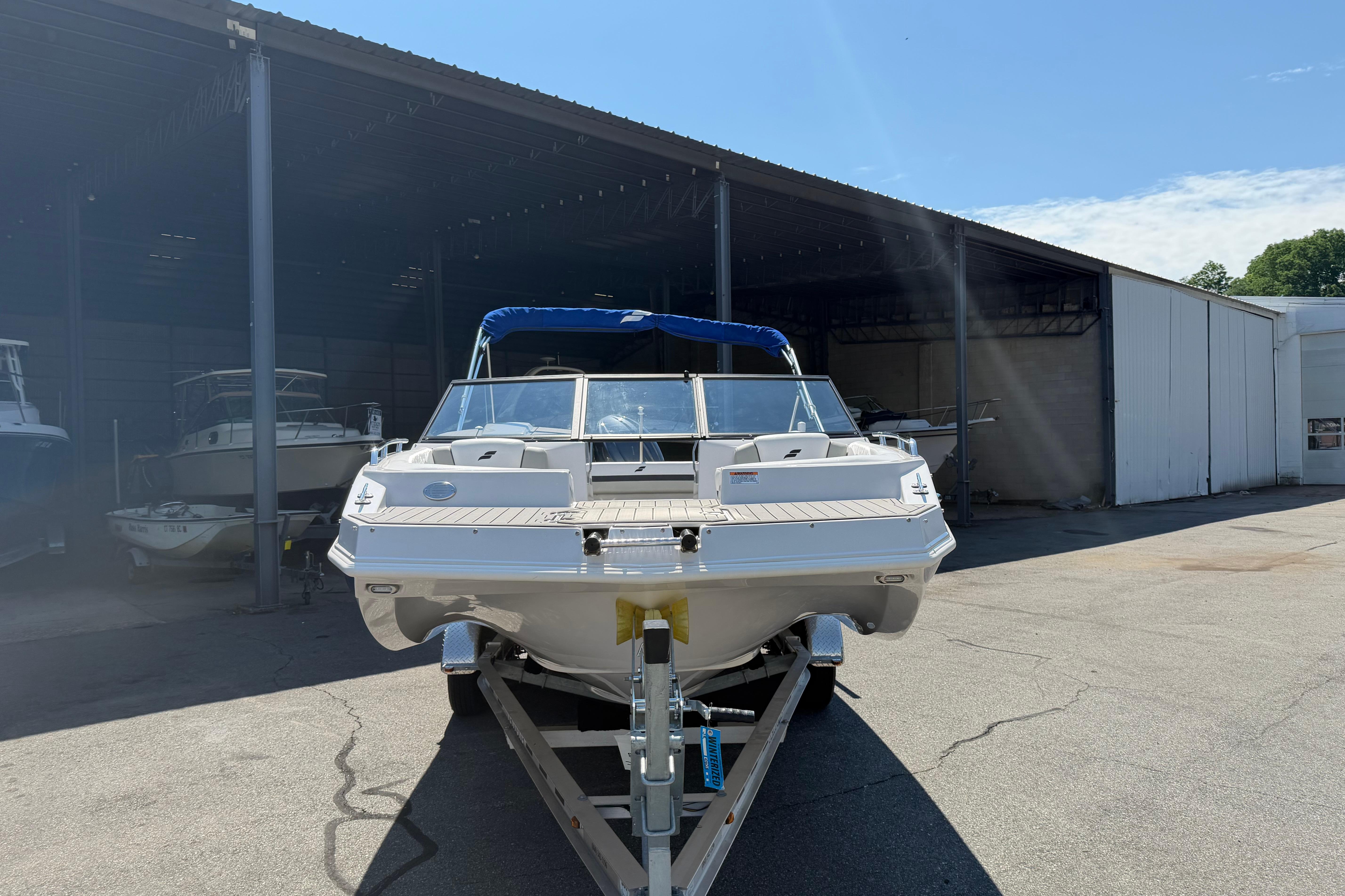 2025 Starcraft SVX 190 OB boat on trailer in marina storage area.