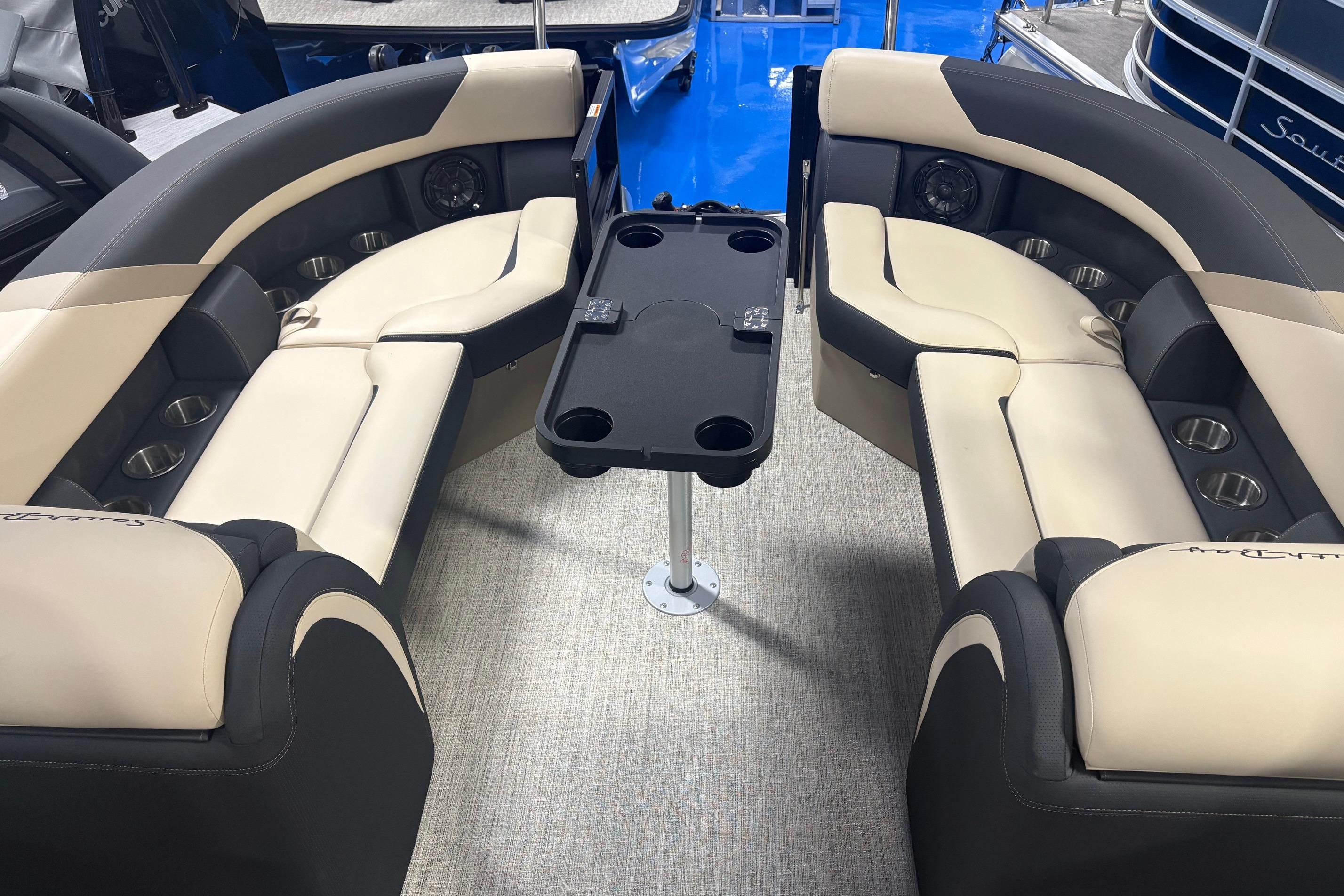 Luxurious 2026 South Bay S224RS boat interior with plush seating and central table.