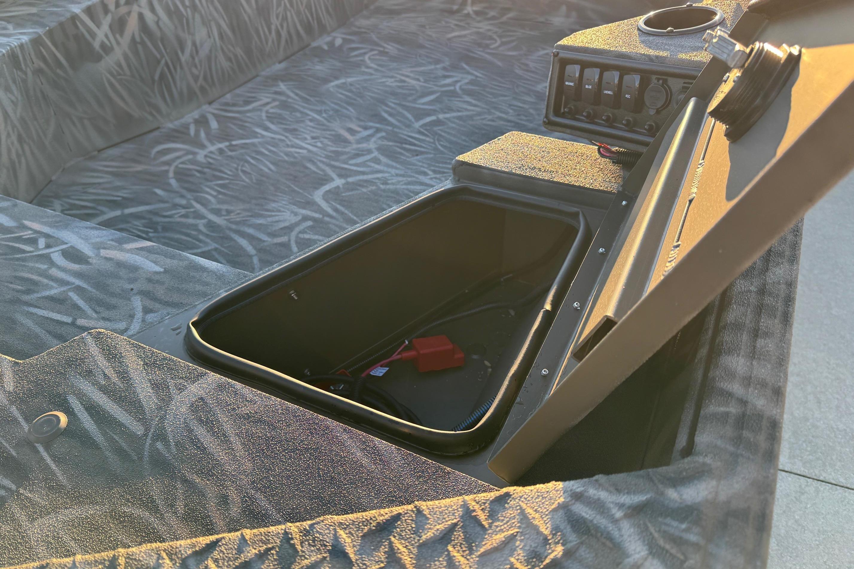 2026 Alweld 1652 Invader boat interior with open storage compartment and control panel.