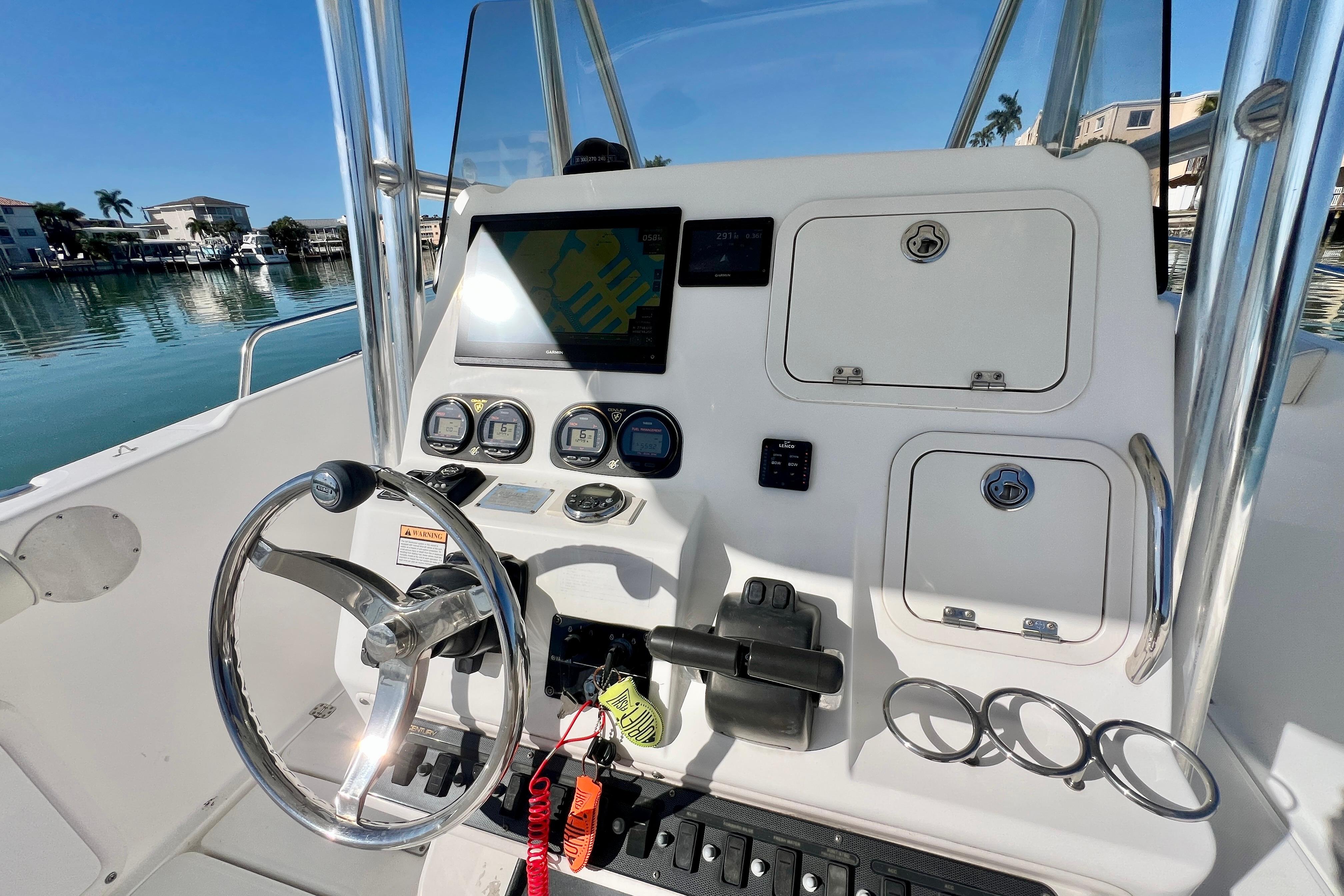 2005 Century 3200 Center Console boat dashboard with steering wheel and navigation controls.