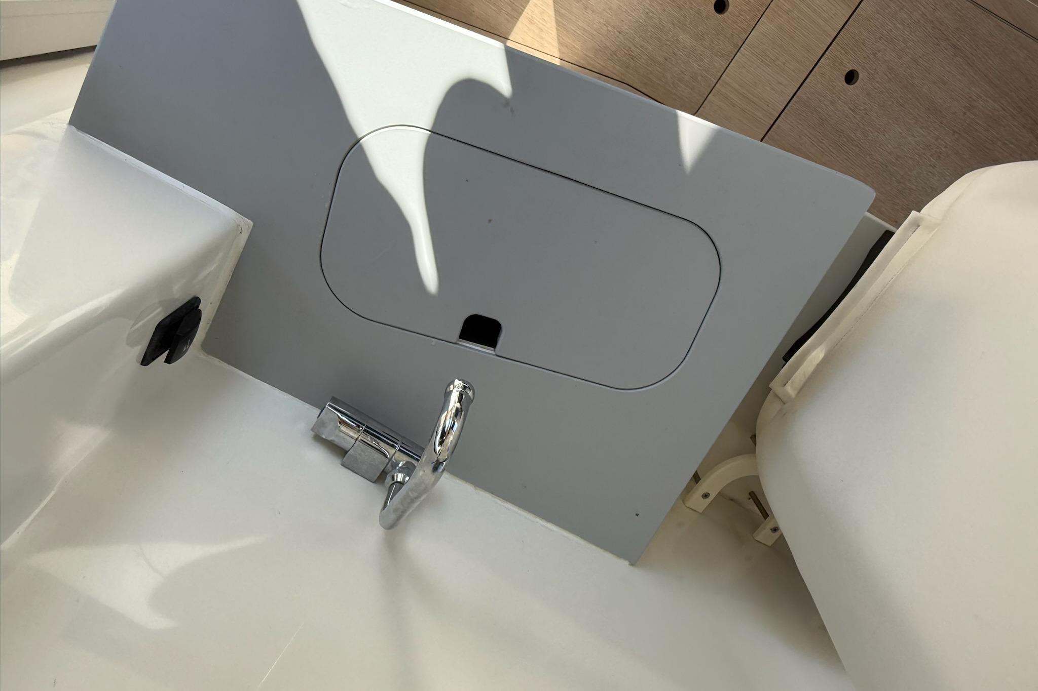 2024 Bayliner Trophy T25 Pilothouse interior detail with faucet and storage compartment.