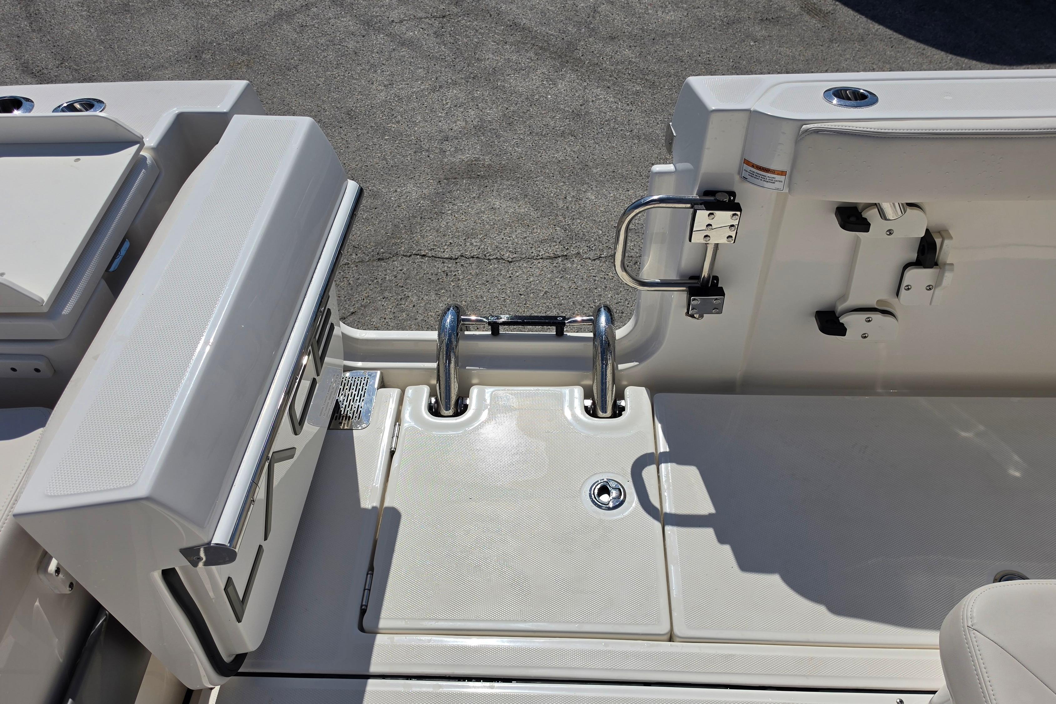 2026 Solace 30CS boat deck with stainless steel ladder and storage compartments.