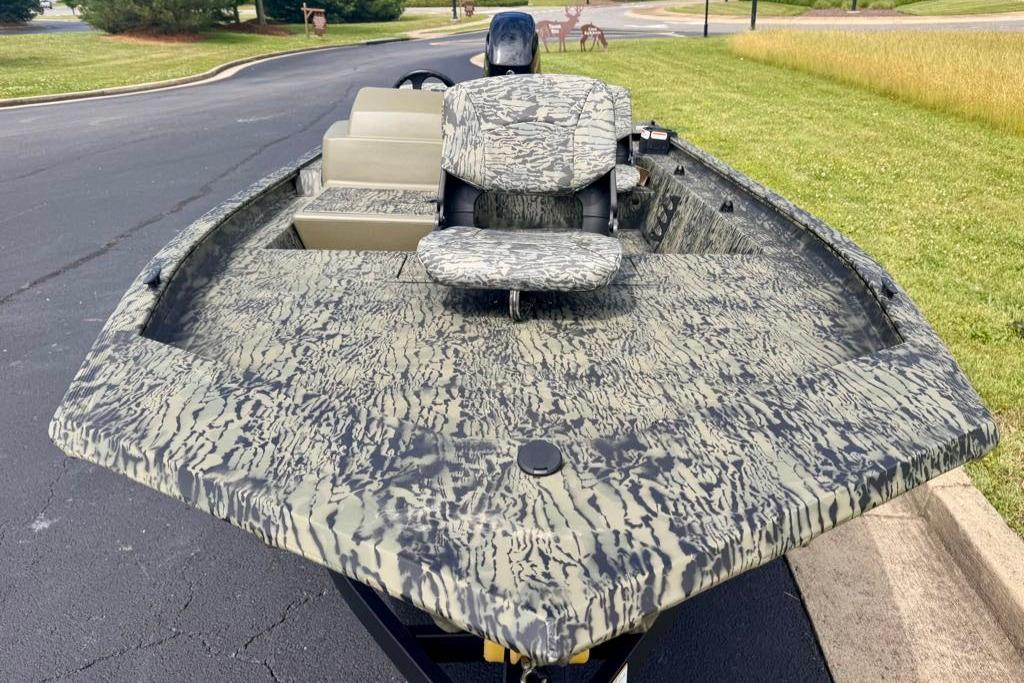 2026 Tracker Grizzly 1754 SC boat with camouflage design on a paved surface.