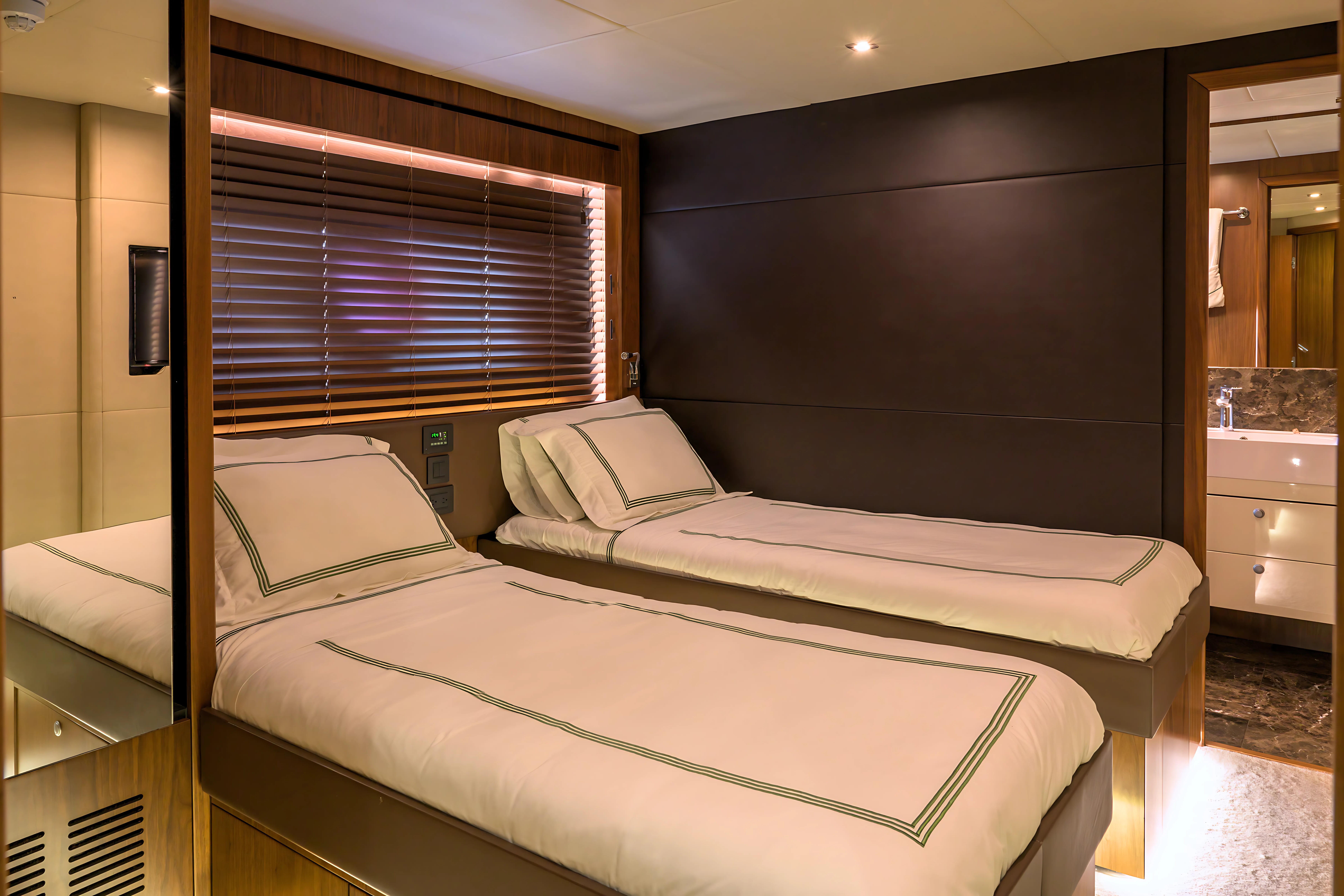Luxurious twin bedroom on 2015 Sunseeker 28 Metre Yacht with modern decor.