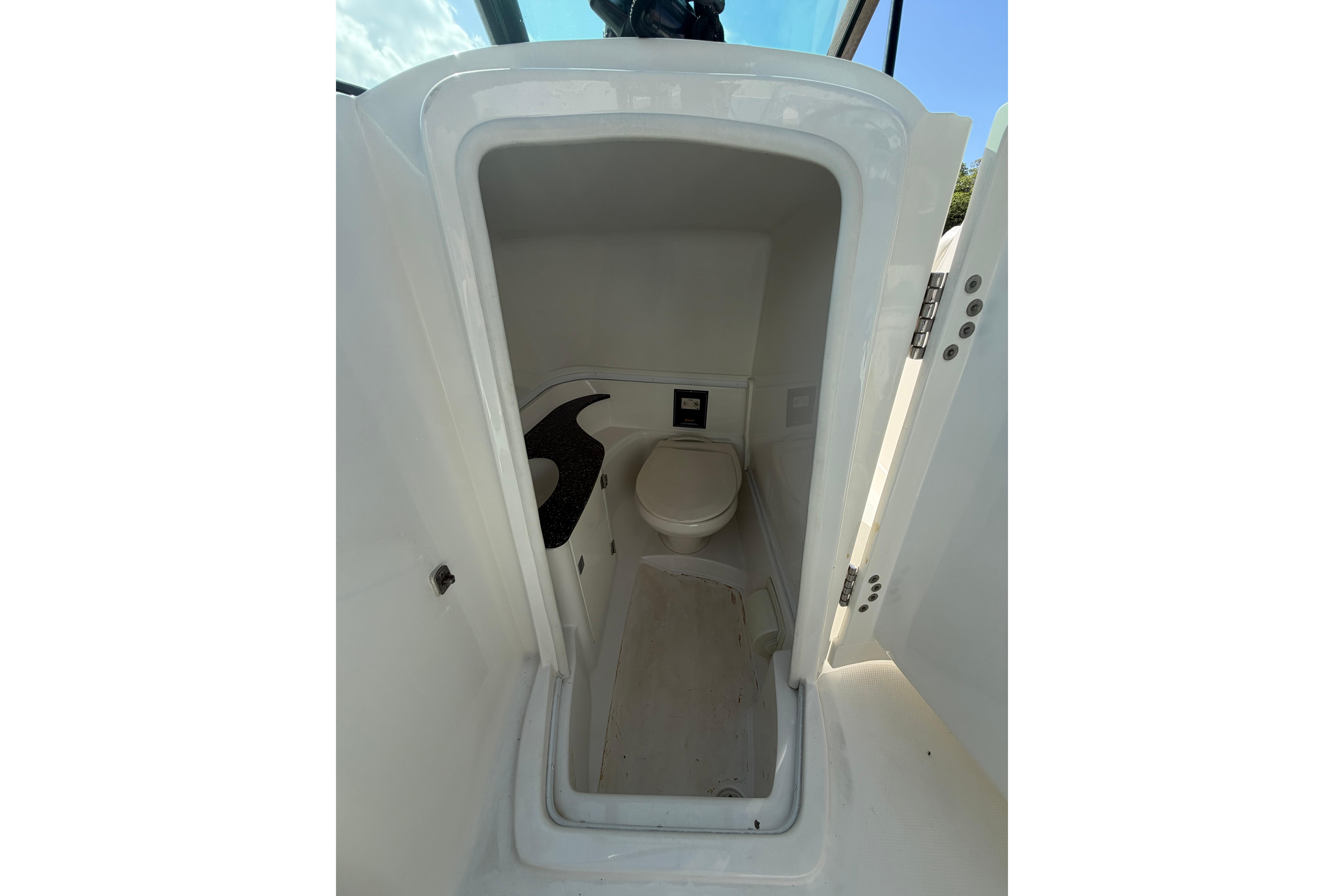 2015 Monterey 264FS boat interior with compact marine toilet.