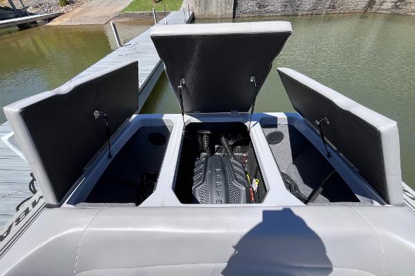 2024 Moomba Max boat engine compartment with open hatches at a dock.