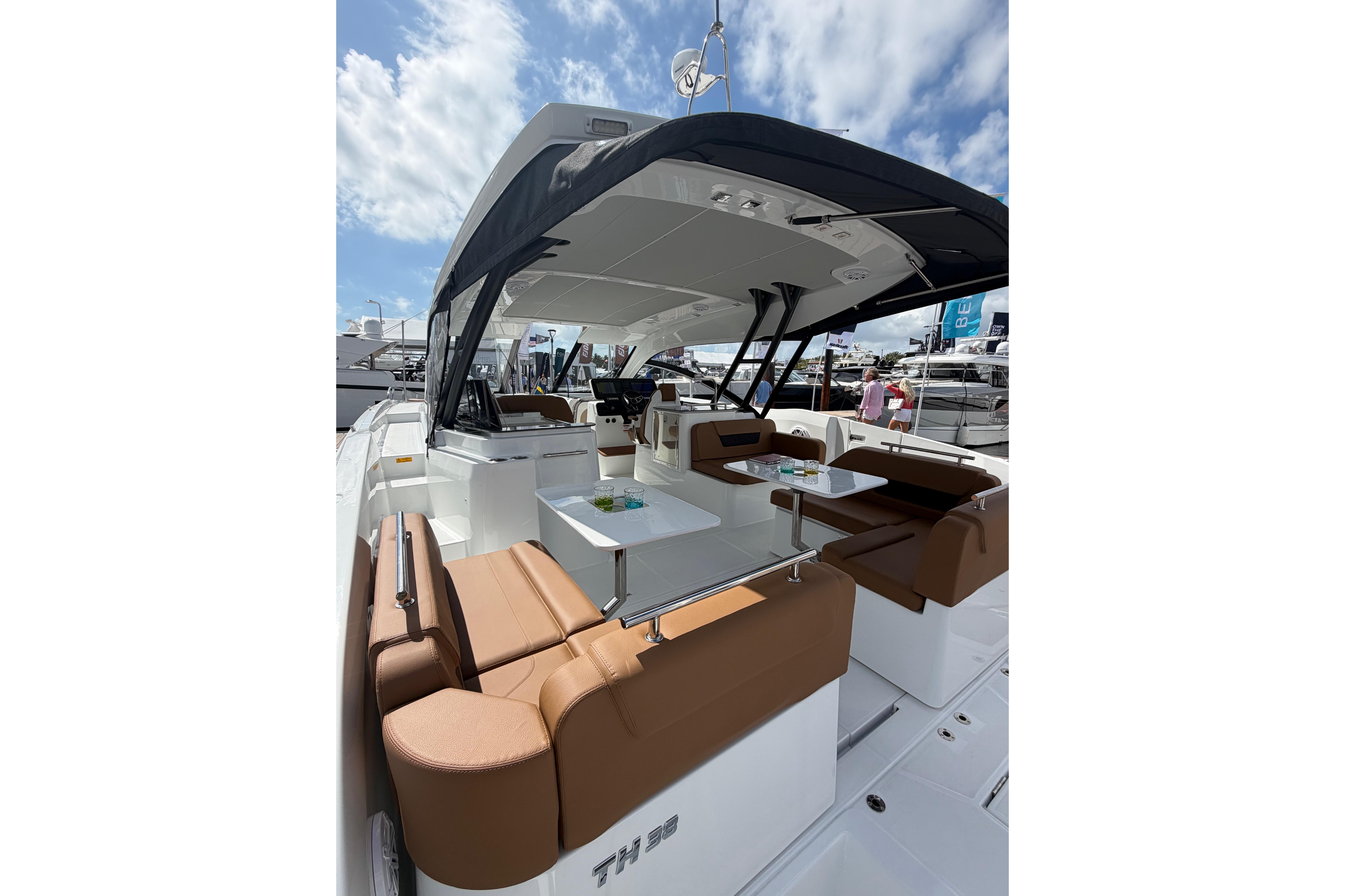 2026 Jeanneau TH38 yacht with spacious seating and modern design under a clear sky.