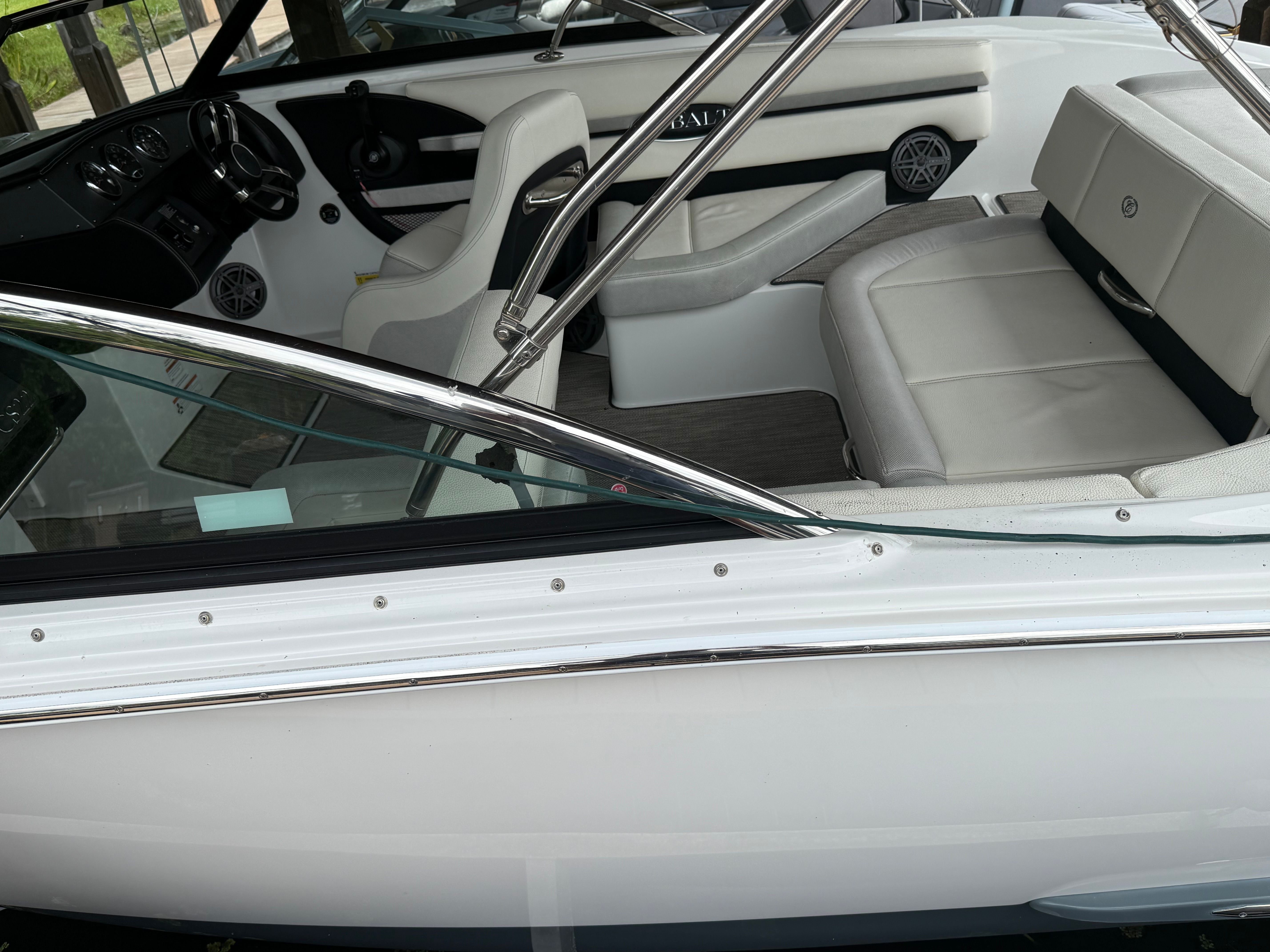 Interior view of a Cobalt CS22 Bowrider with white seats and black dashboard.