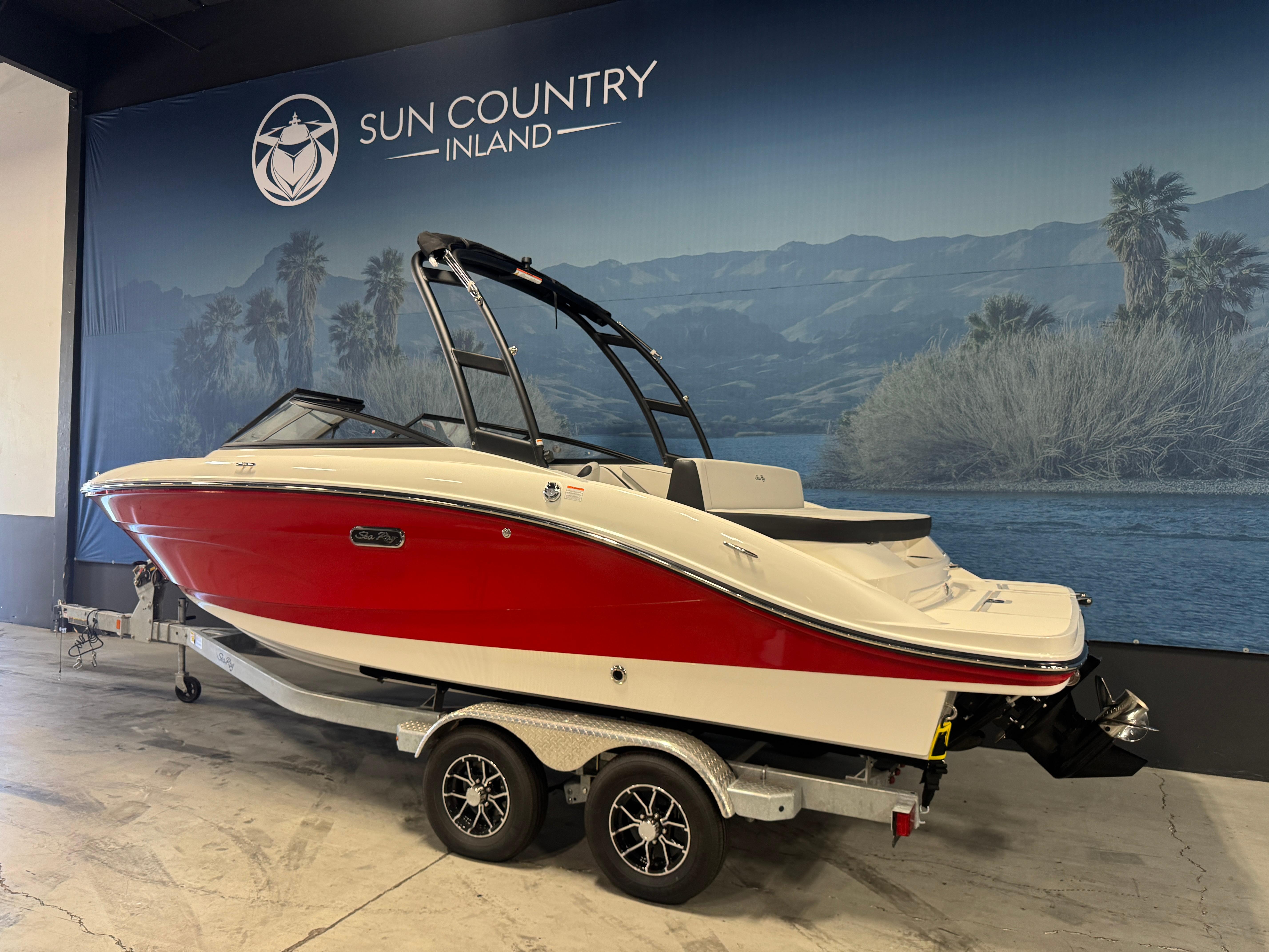2026 Sea Ray SPX 210 boat in showroom, red and white design, on trailer.