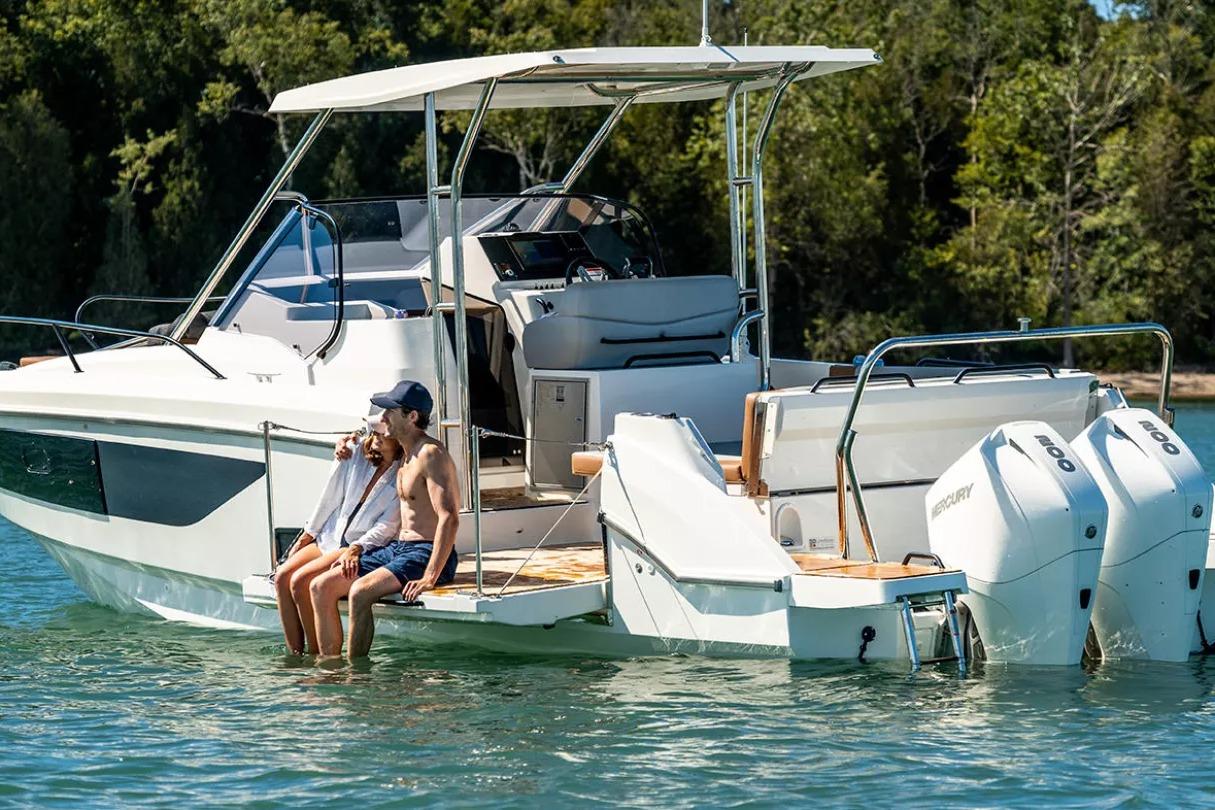 Beneteau Flyer 9 SUNdeck 2026 on water with two people.