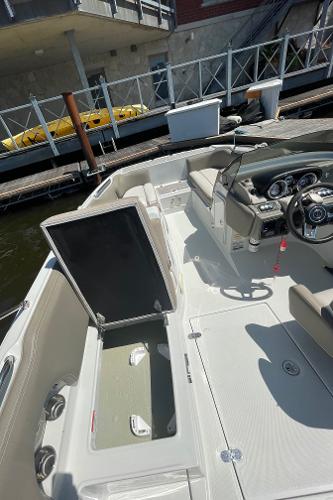 2020 Crownline E 205 XS boat interior with open storage compartment, docked by the water.