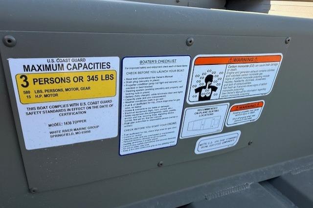 Boat safety labels on a 2026 Tracker Grizzly 14 Jon, showing capacity and warnings.