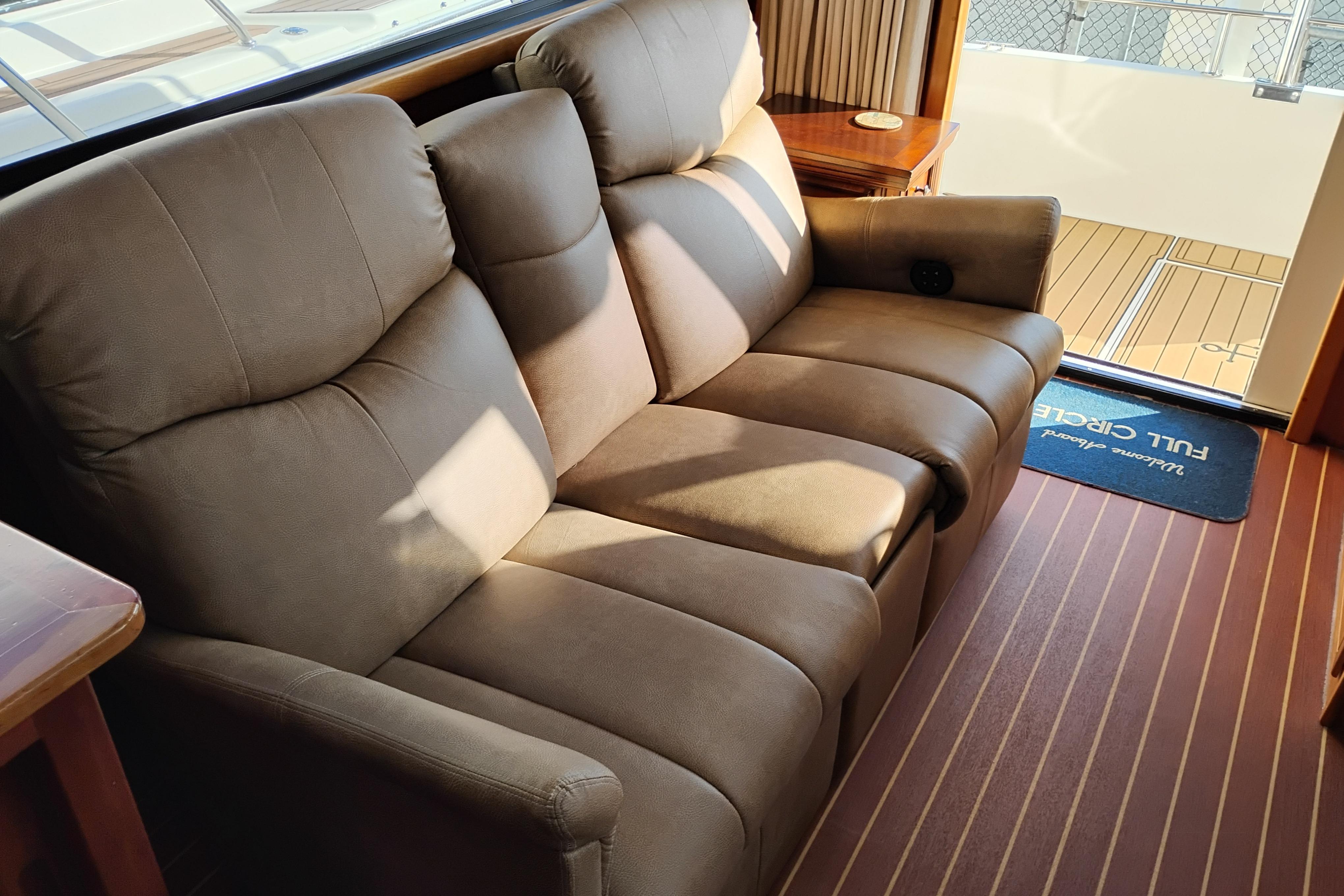 Luxurious interior of 2002 Canoe Cove 50 Pilothouse Motor Yacht with plush seating.