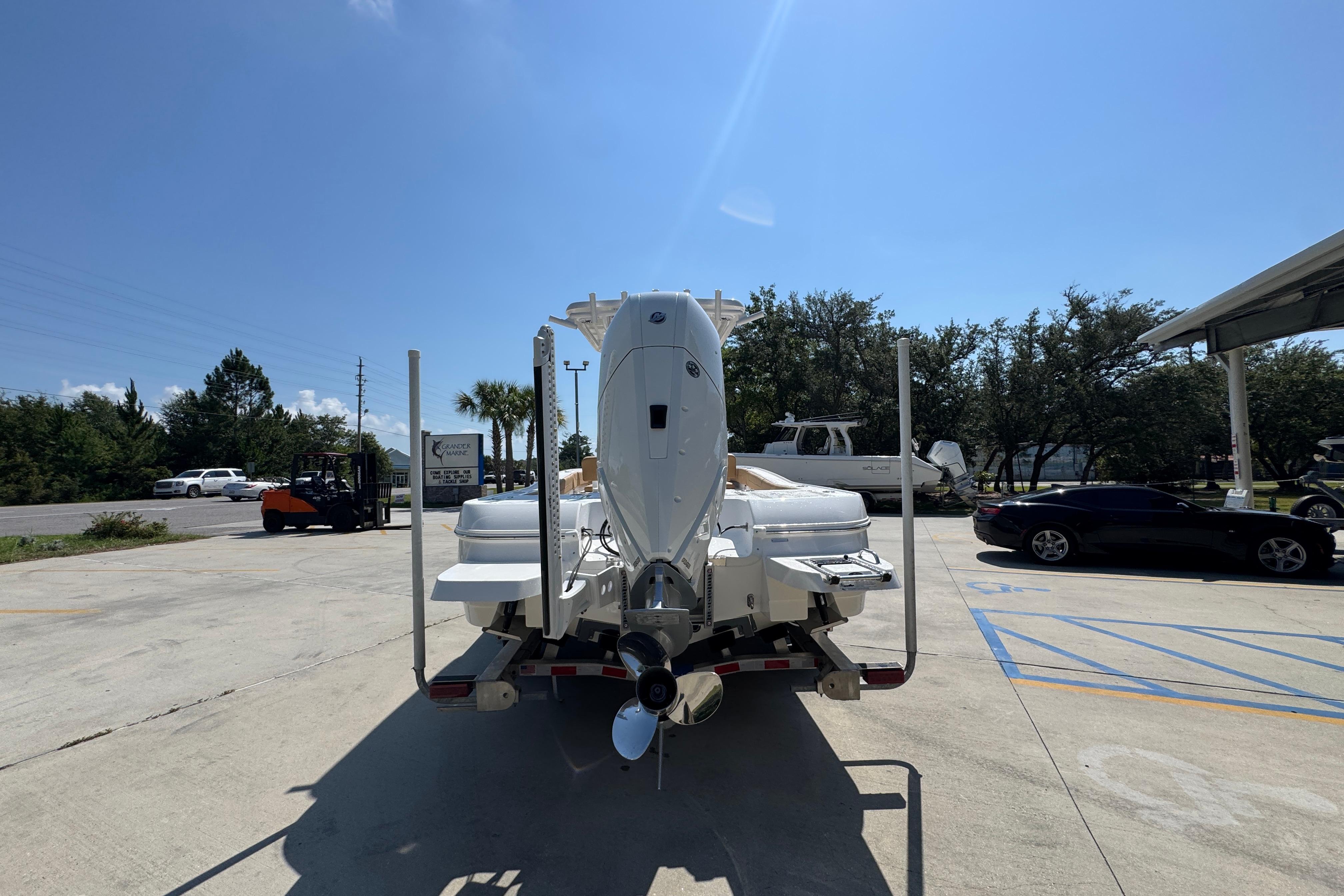2027 Caymas 26 HB boat on trailer in sunny outdoor setting.