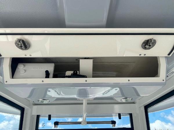 2023 Robalo R270 boat storage compartment with open hatch.