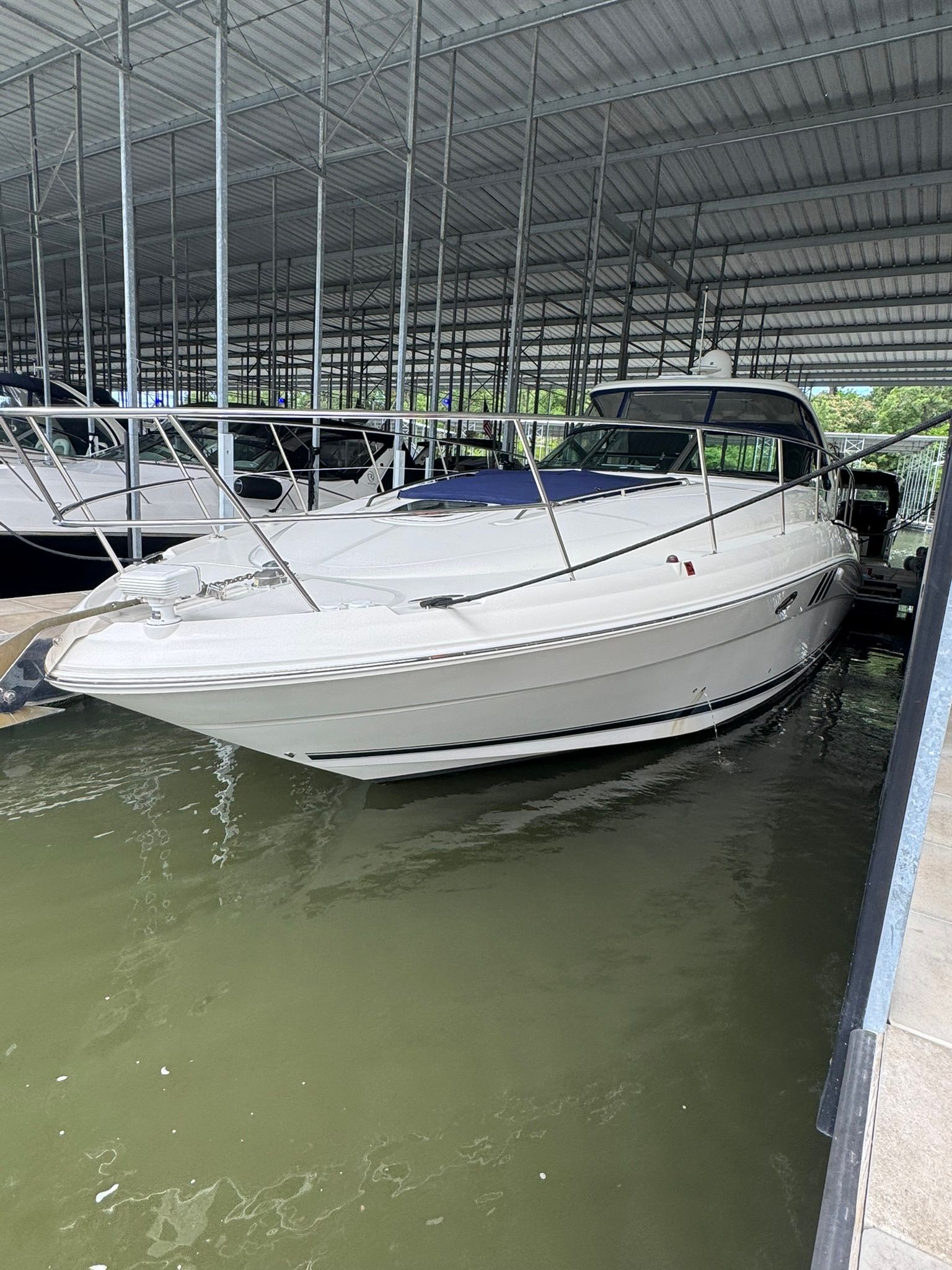 A 2007 Sea Ray 40 Sundancer docked in a covered marina.