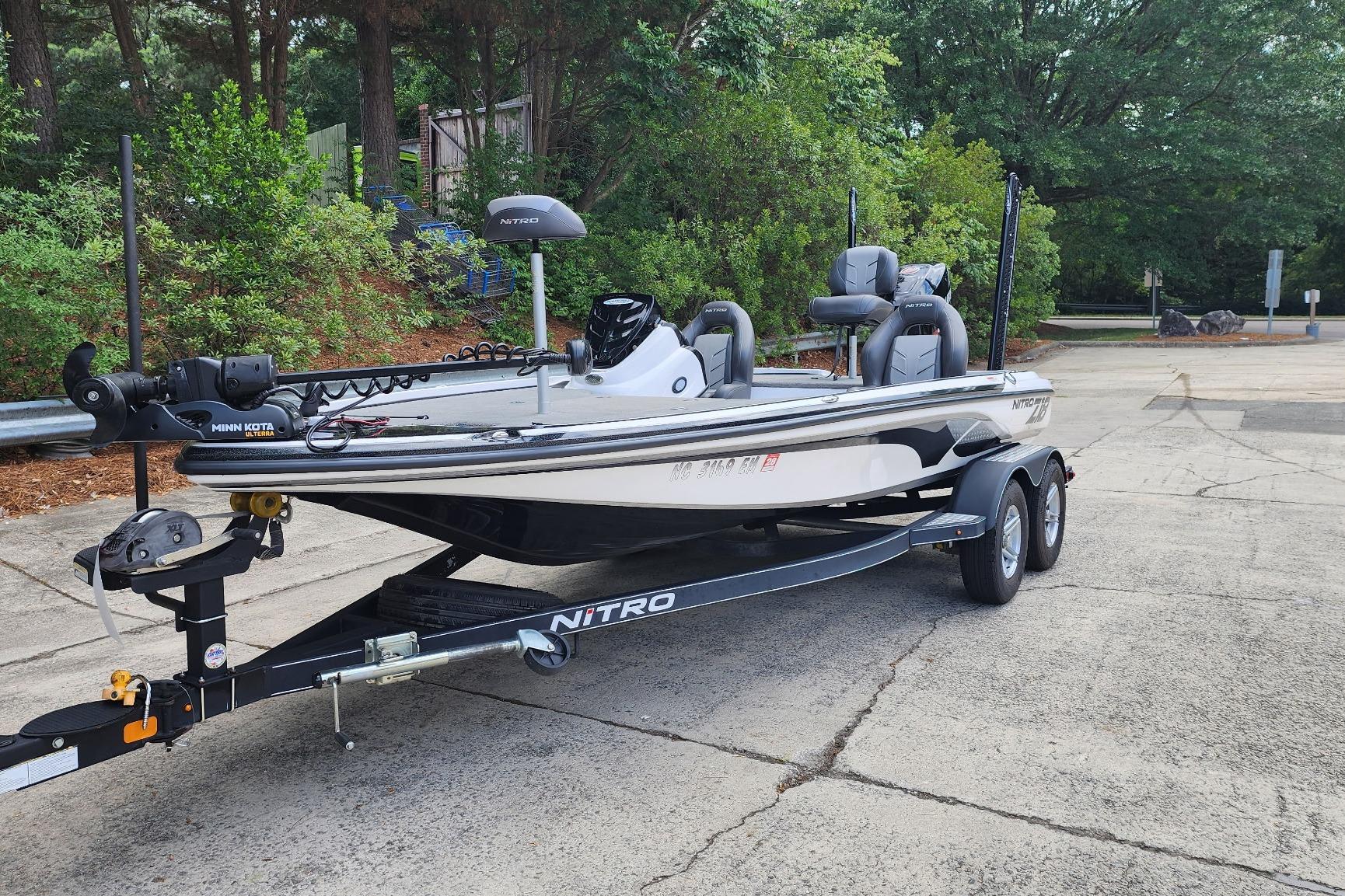 2017 Nitro Z18 fishing boat on trailer, parked outdoors with lush greenery background.