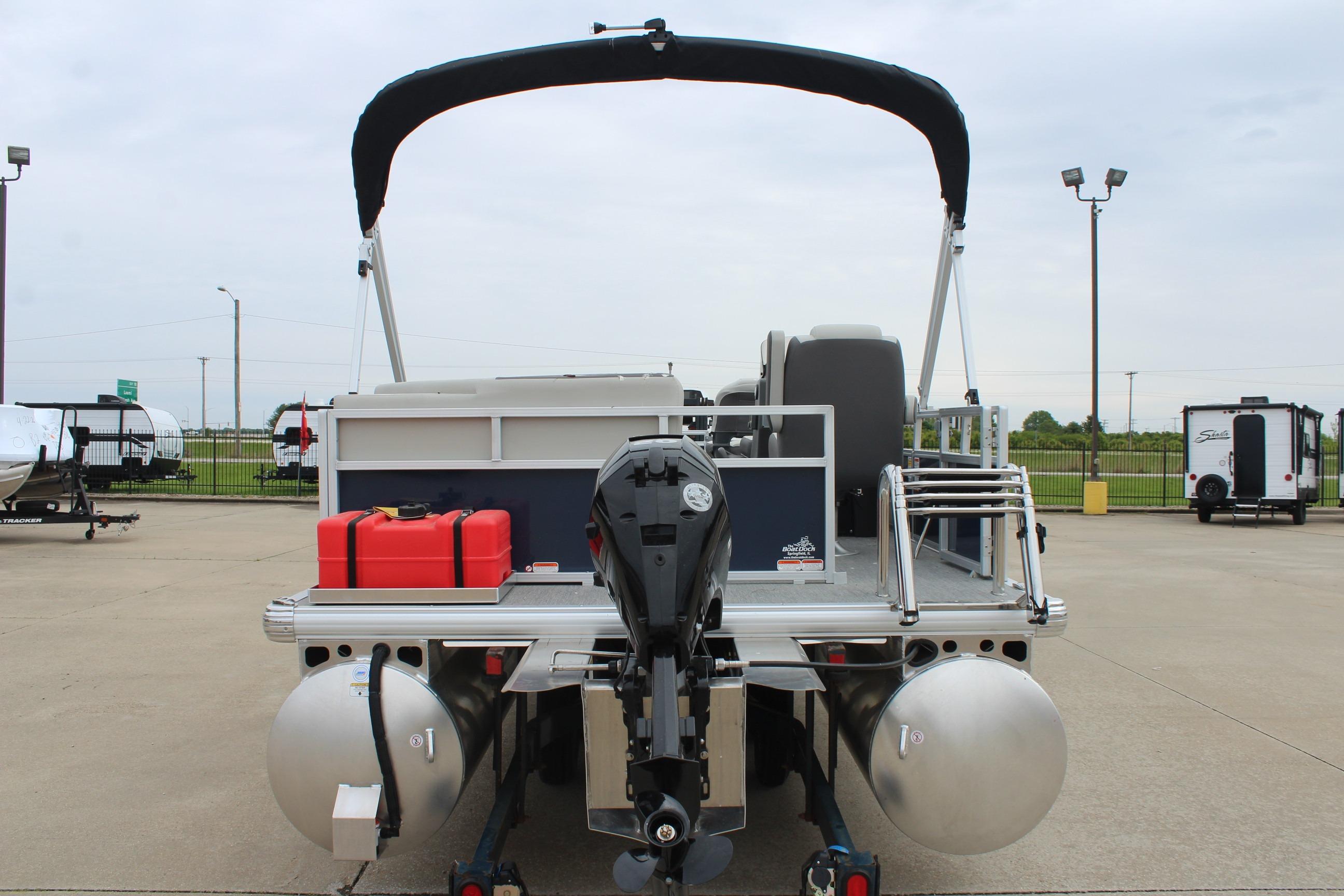 2026 Sun Tracker Bass Buggy 16 XL Select pontoon boat, rear view with motor and fuel tanks.