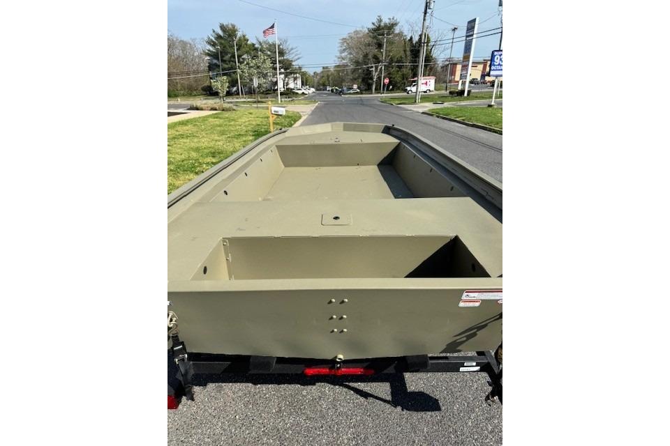 2026 Tracker Grizzly 1860 Utility boat on trailer, parked on a suburban street.