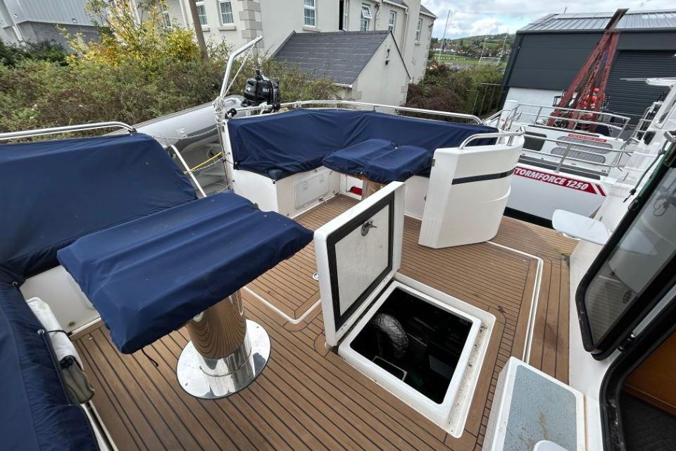 2018 Redbay Boats 1650 Explorer Cabin RIB with blue seating and open hatch on deck.