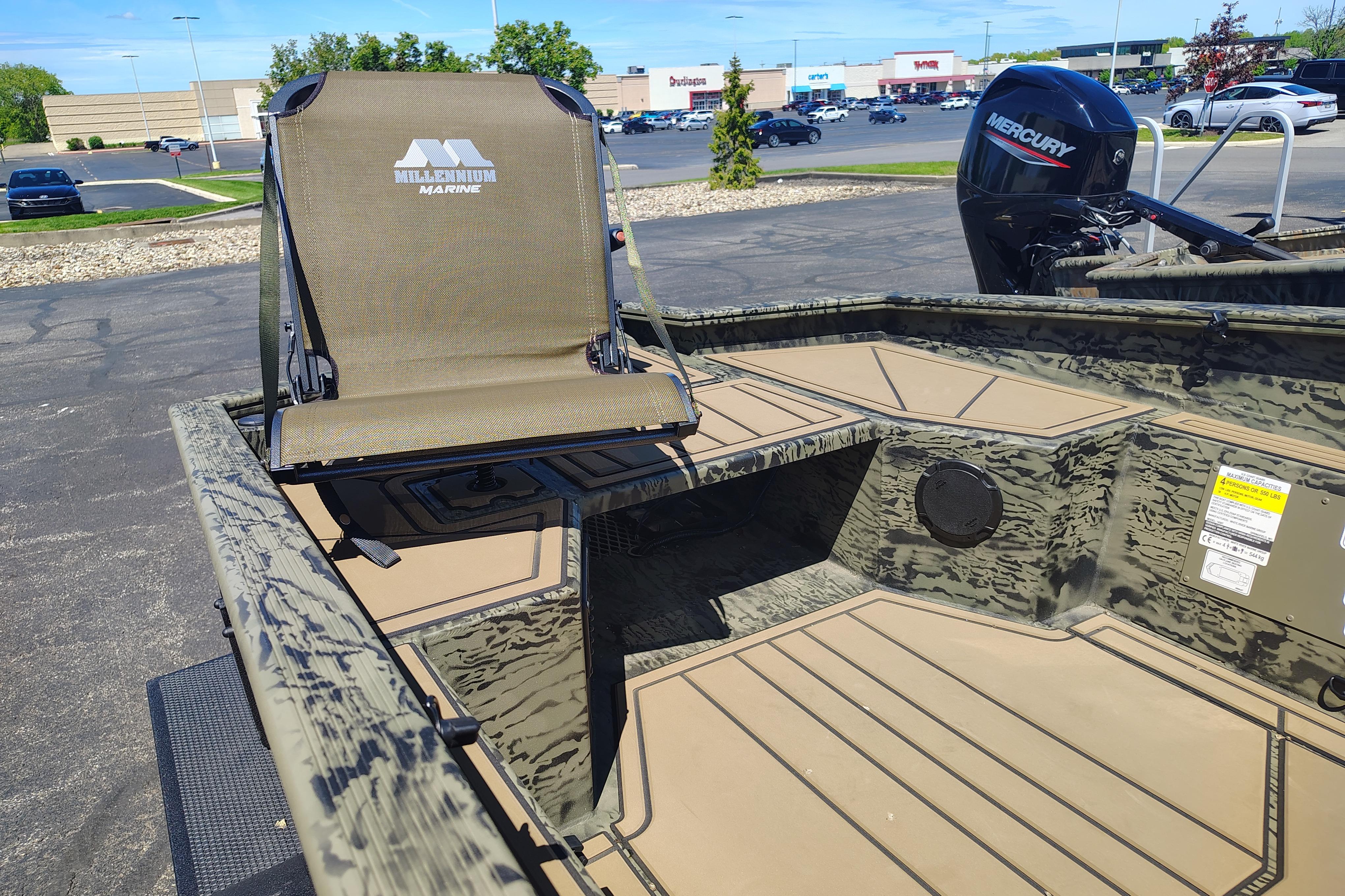 2026 Tracker Grizzly 1650 T Prairie Wings Edition boat with Mercury engine in parking lot.