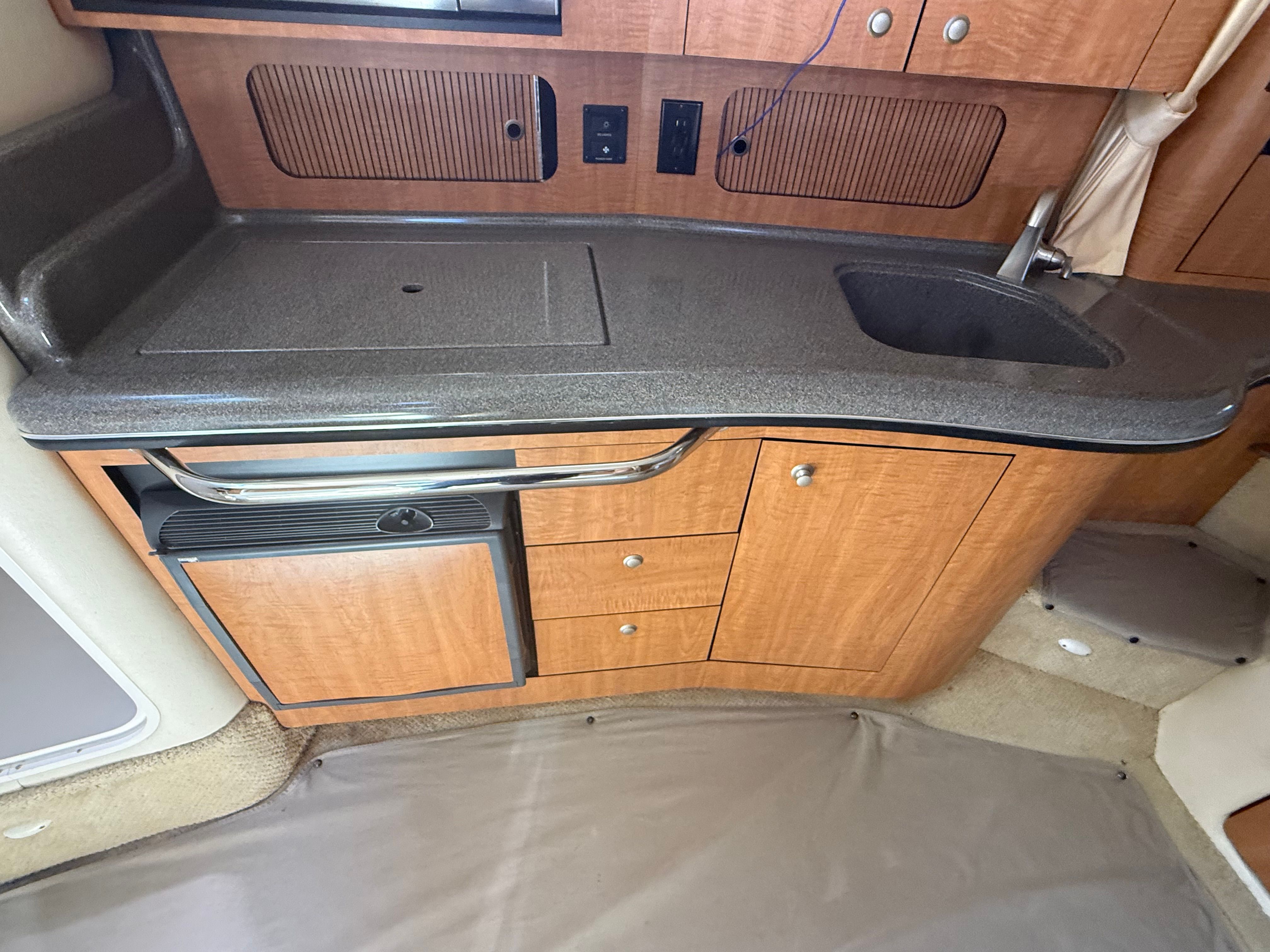Galley in a 2006 Sea Ray Sundancer 320 with sink and cabinets.