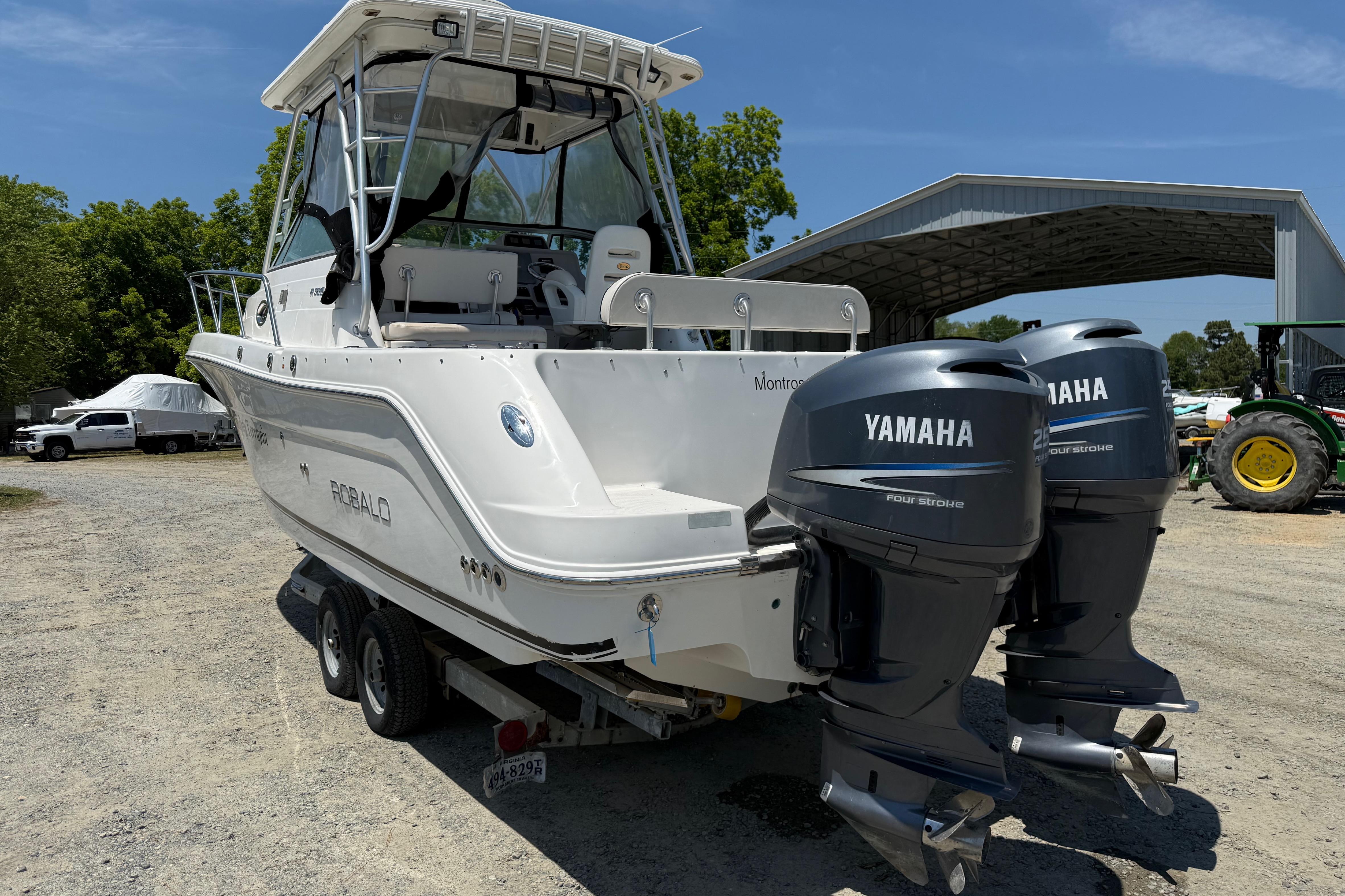 2007 Robalo R305 Walkaround boat with dual Yamaha engines on a trailer.