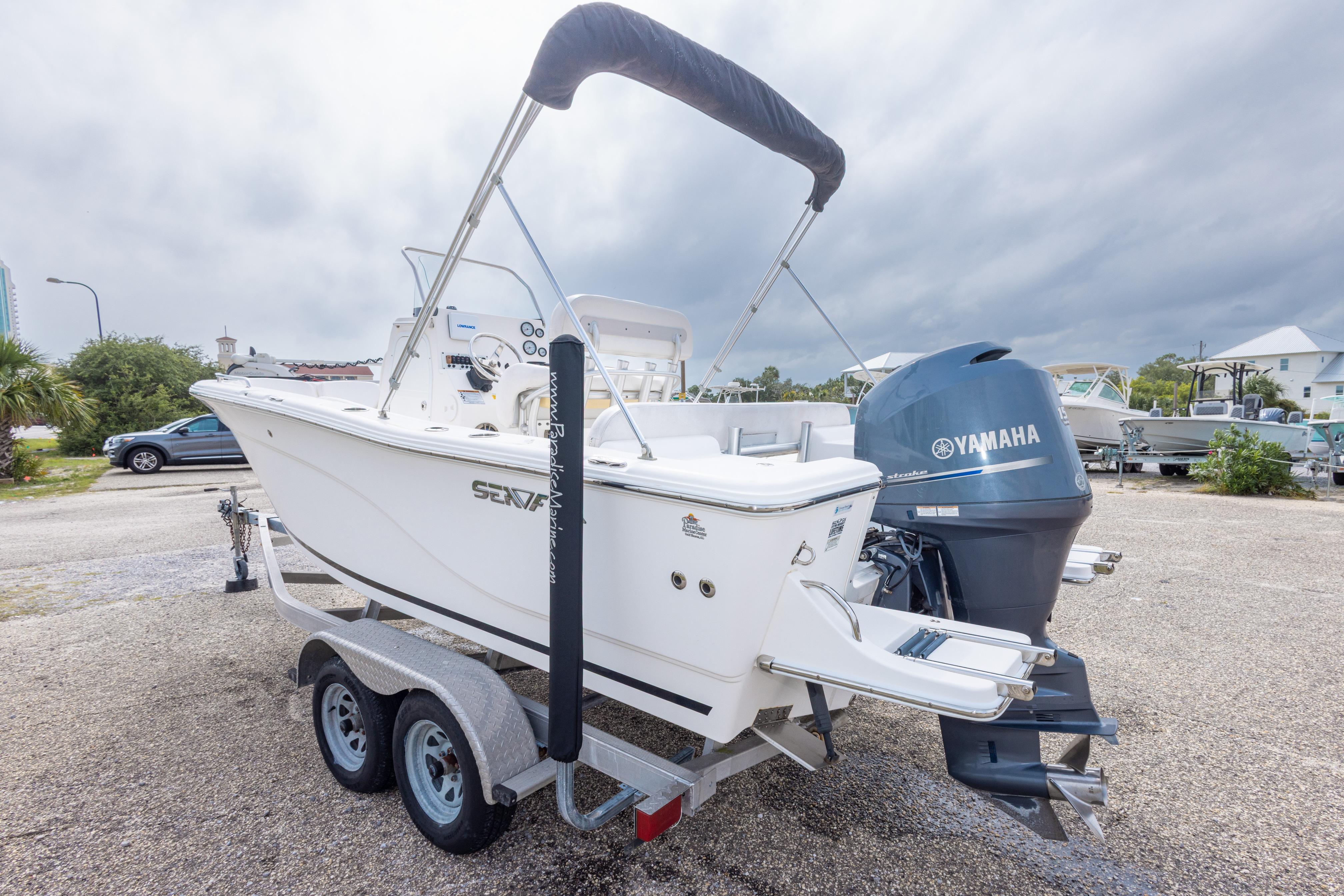2014 Sea Fox 209 Commander boat on trailer with Yamaha engine, parked outdoors.