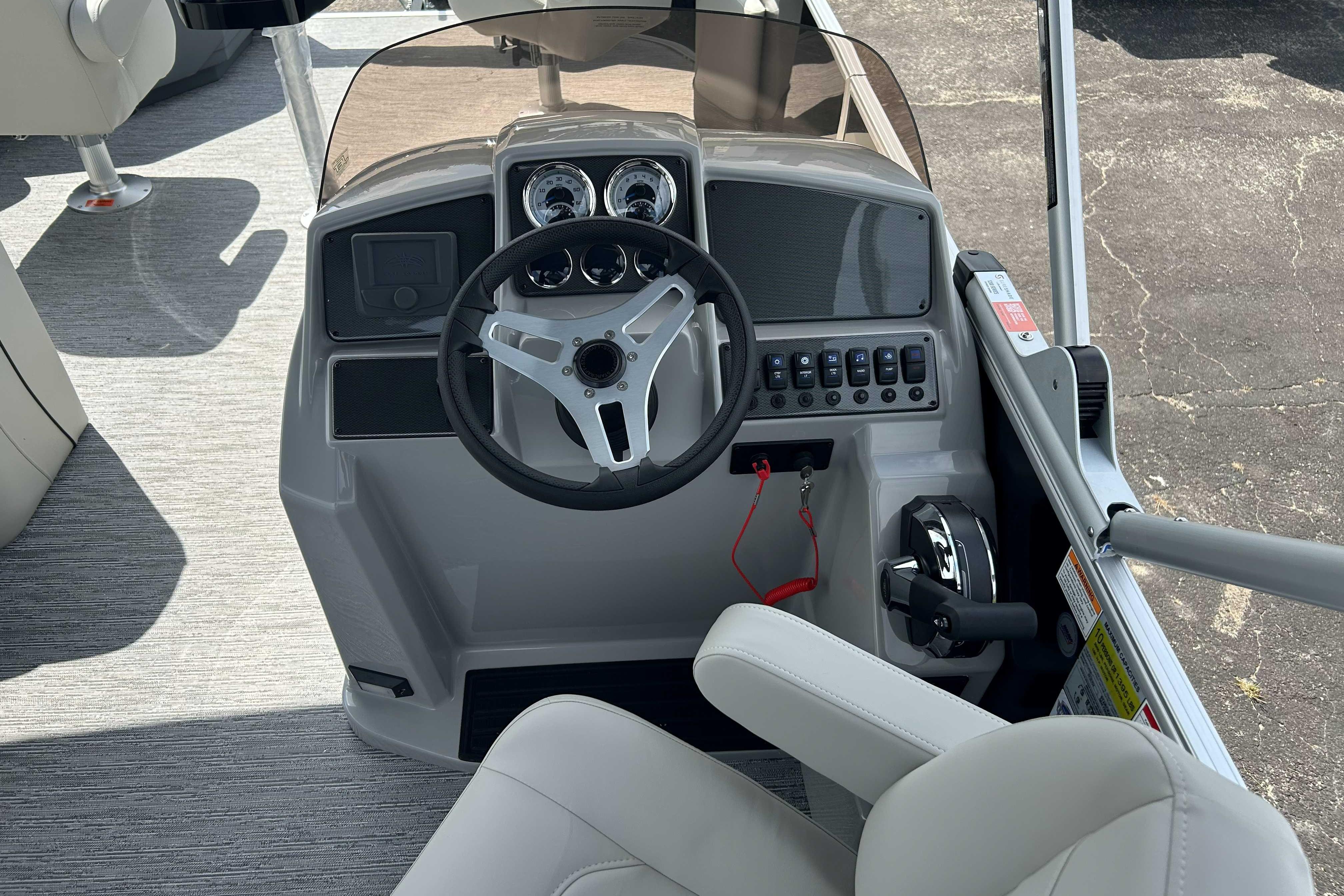 2026 Starcraft EX 22 FD boat helm with steering wheel and control panel.