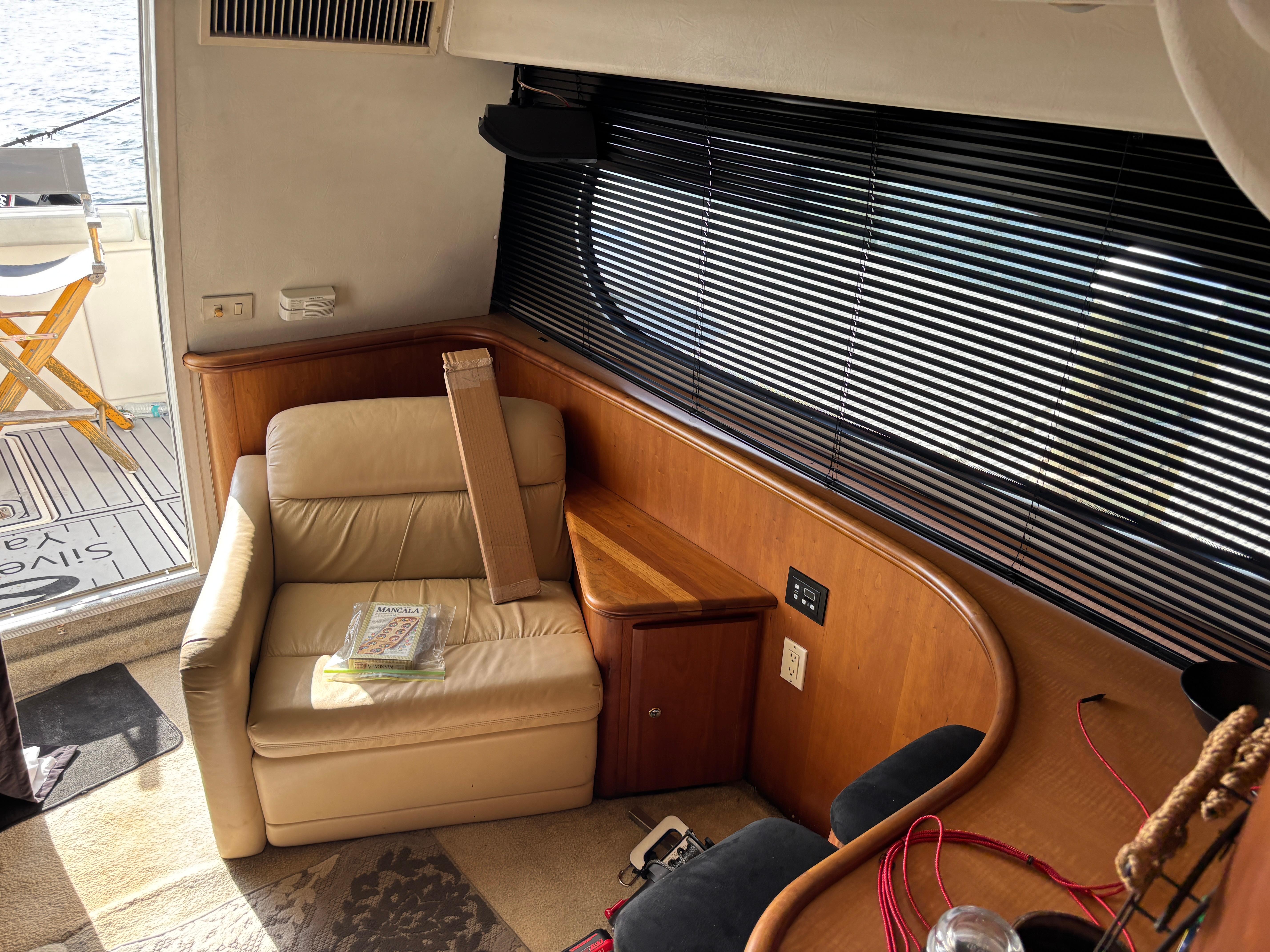 Interior of 2001 Silverton 410 Sport Bridge with leather chair and wooden accents.