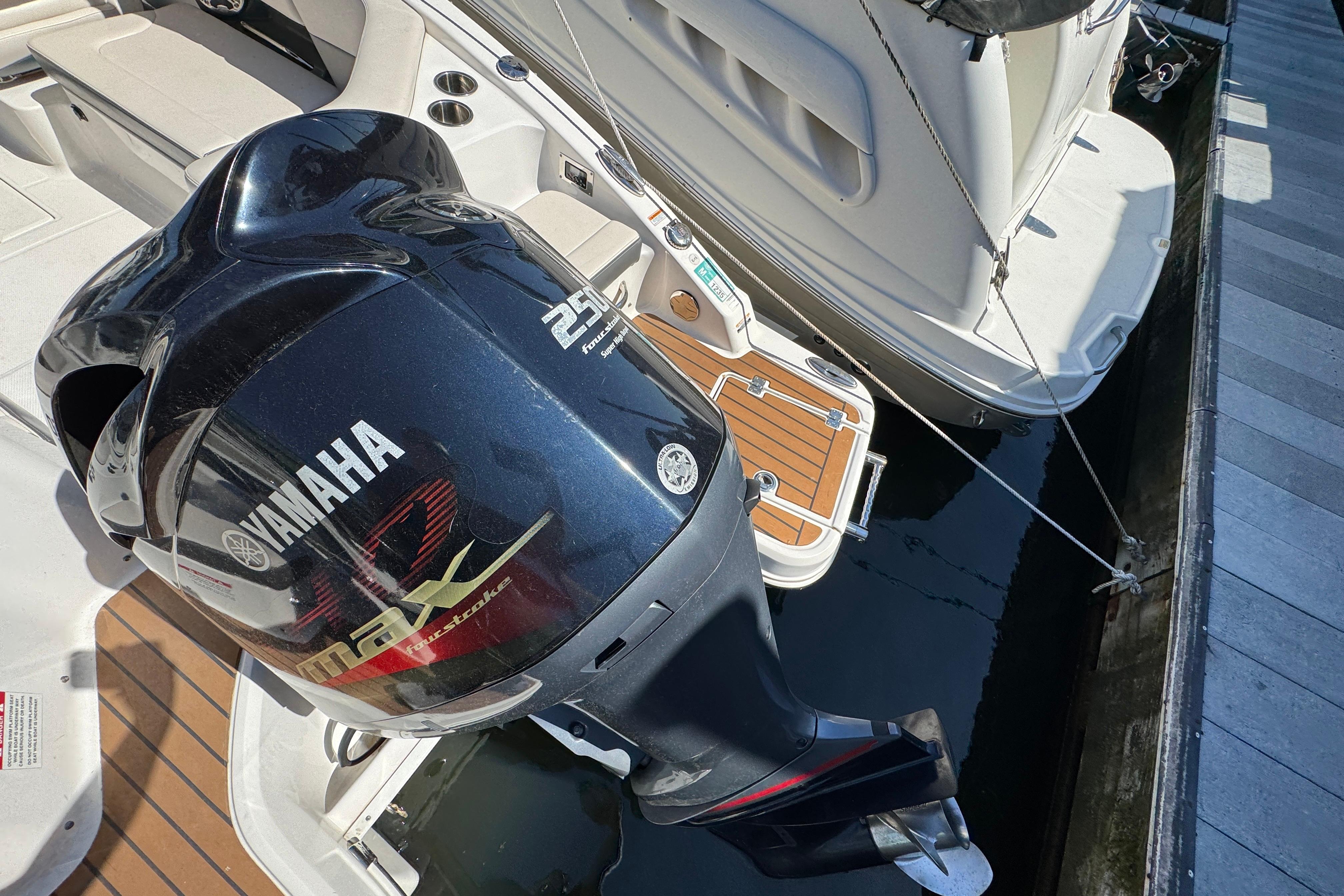 2018 Chaparral 250 Suncoast with Yamaha outboard motor docked at marina.