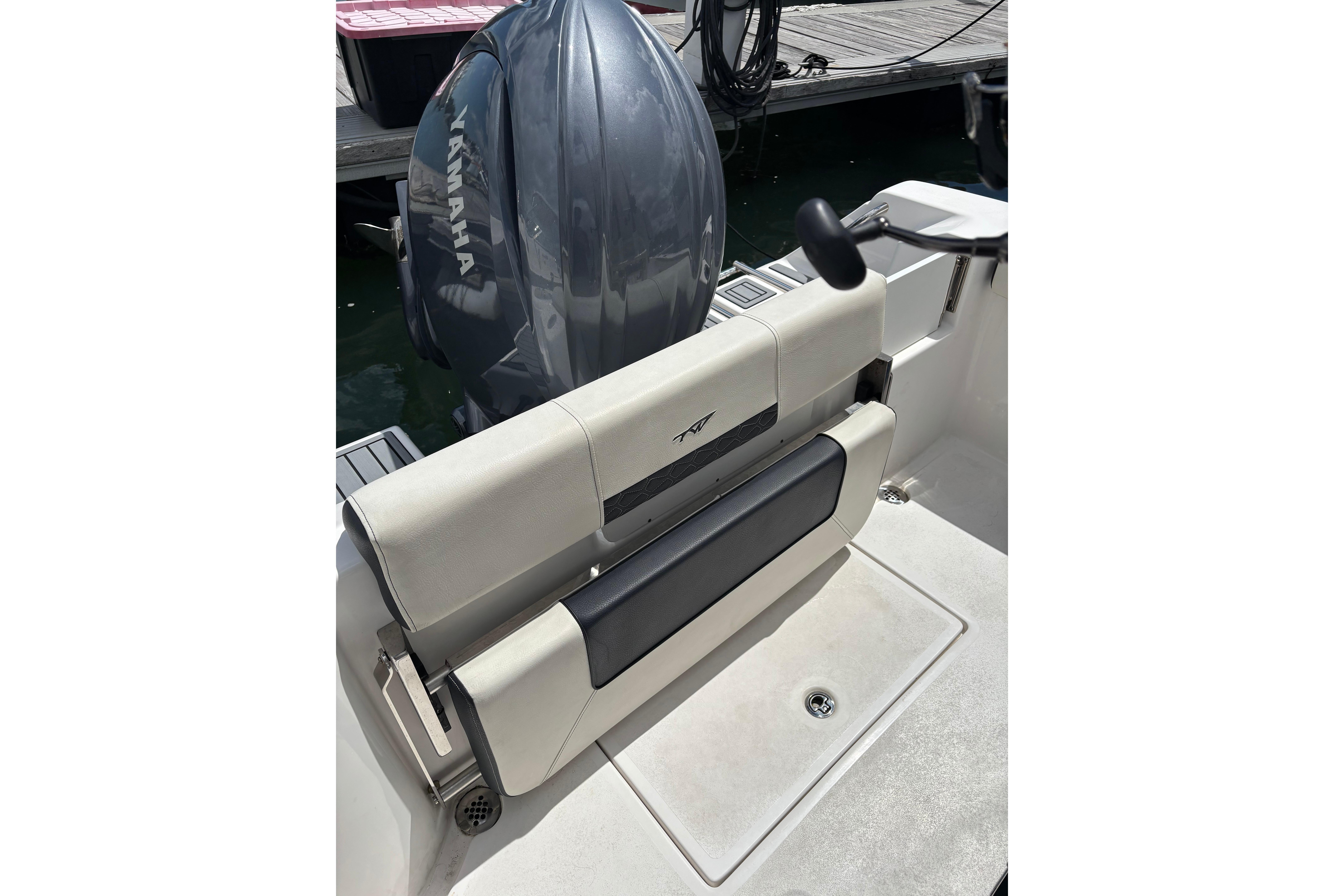 2024 Tidewater 220 CC Adventure boat with Yamaha outboard engine at dock.