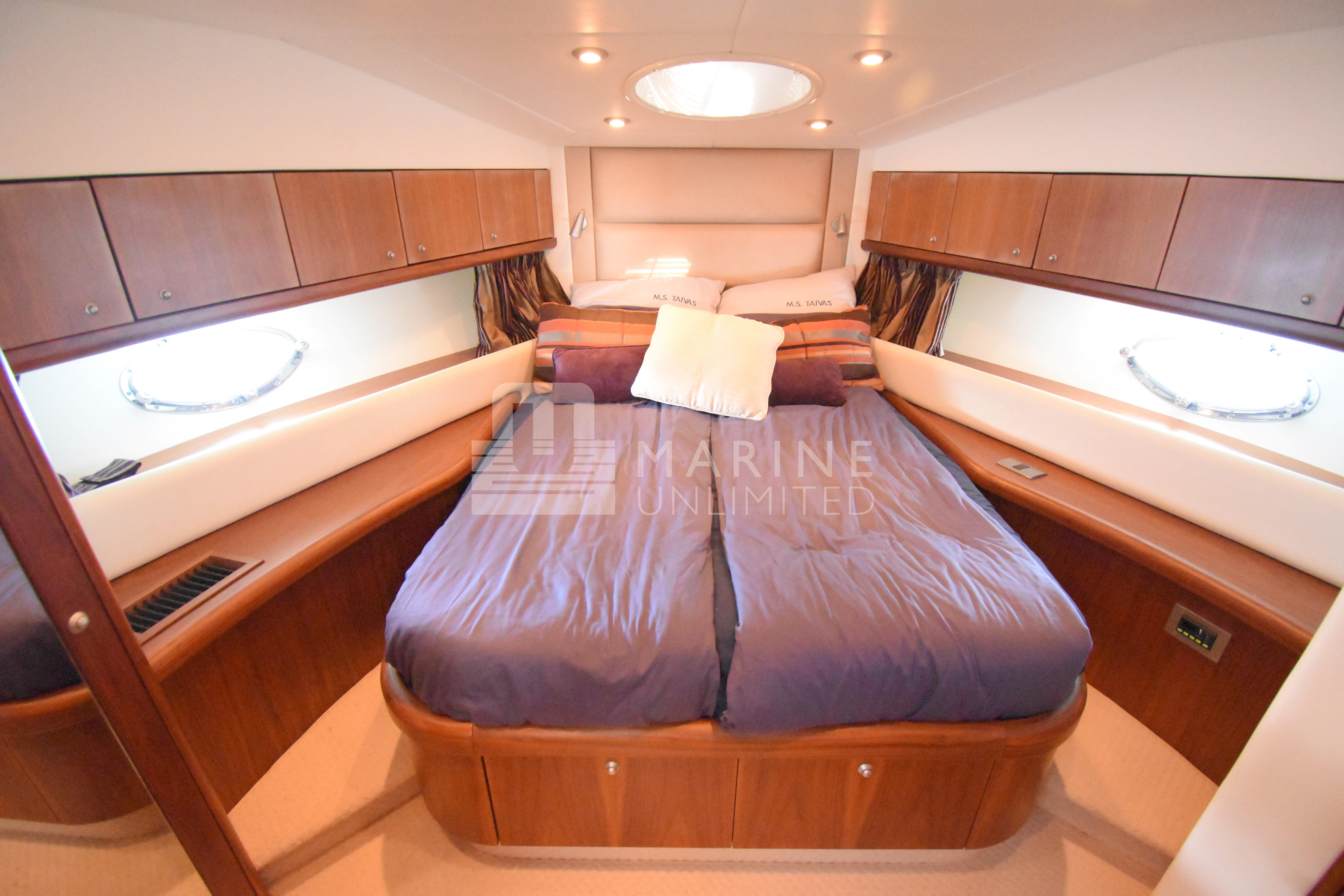 Luxurious cabin interior of 2010 Sunseeker Manhattan 52 yacht with cozy bedding.
