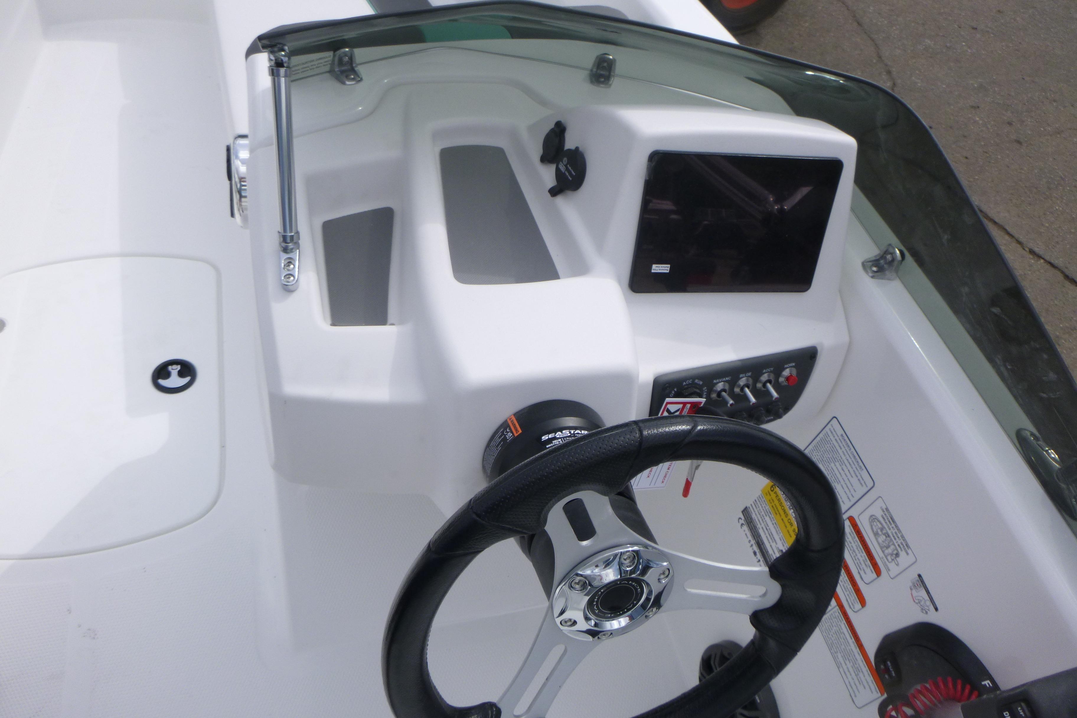 2026 Tahoe T16 boat dashboard with steering wheel and control panel.