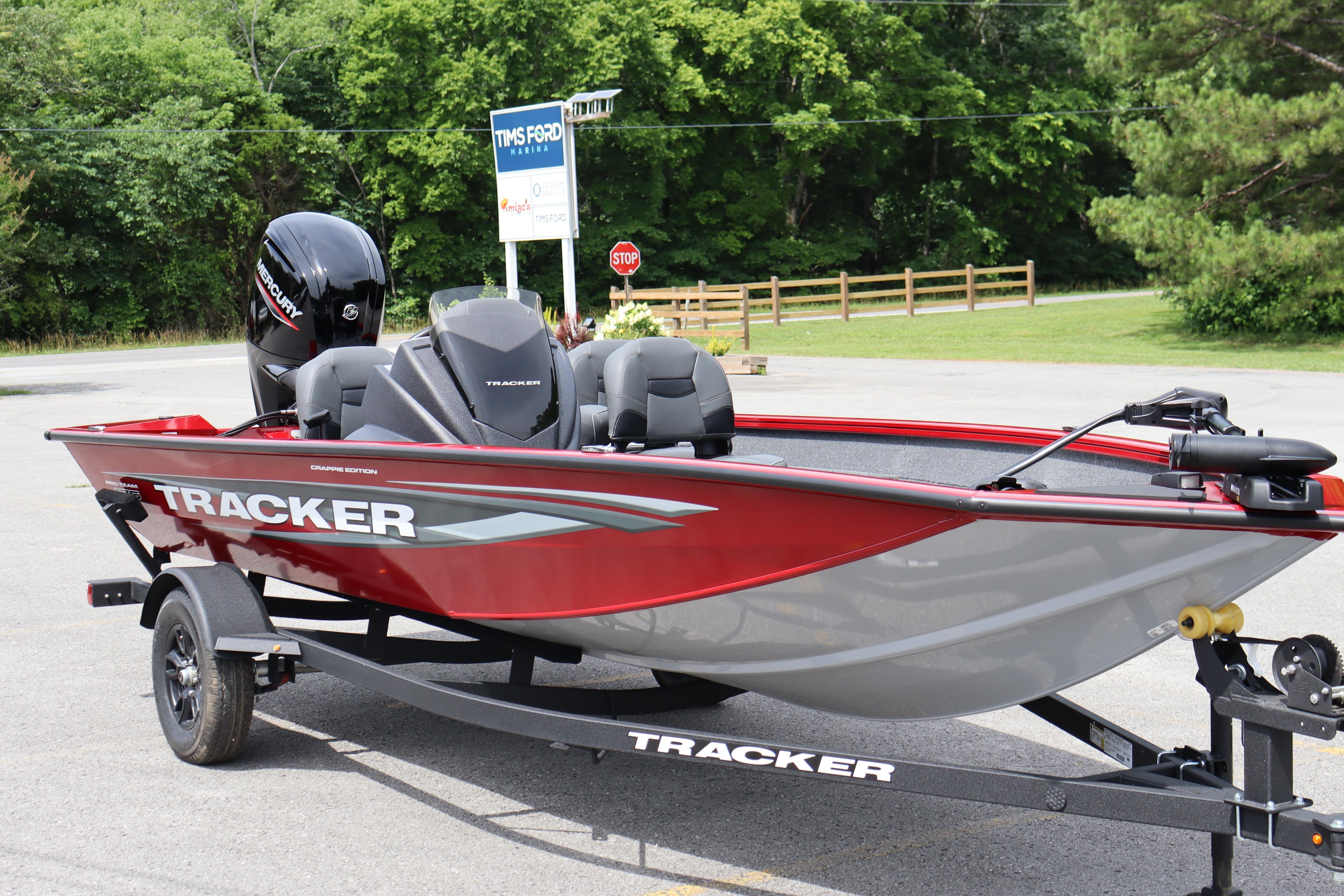 2026 Tracker Pro Team 175 Crappie Edition boat, red and gray, parked on trailer.