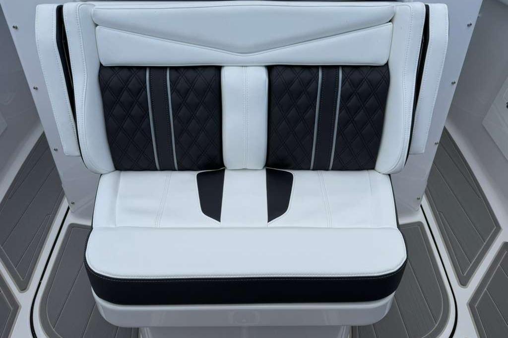Luxury seating on 2026 Monterey Elite 30 OB boat, featuring elegant black and white upholstery.