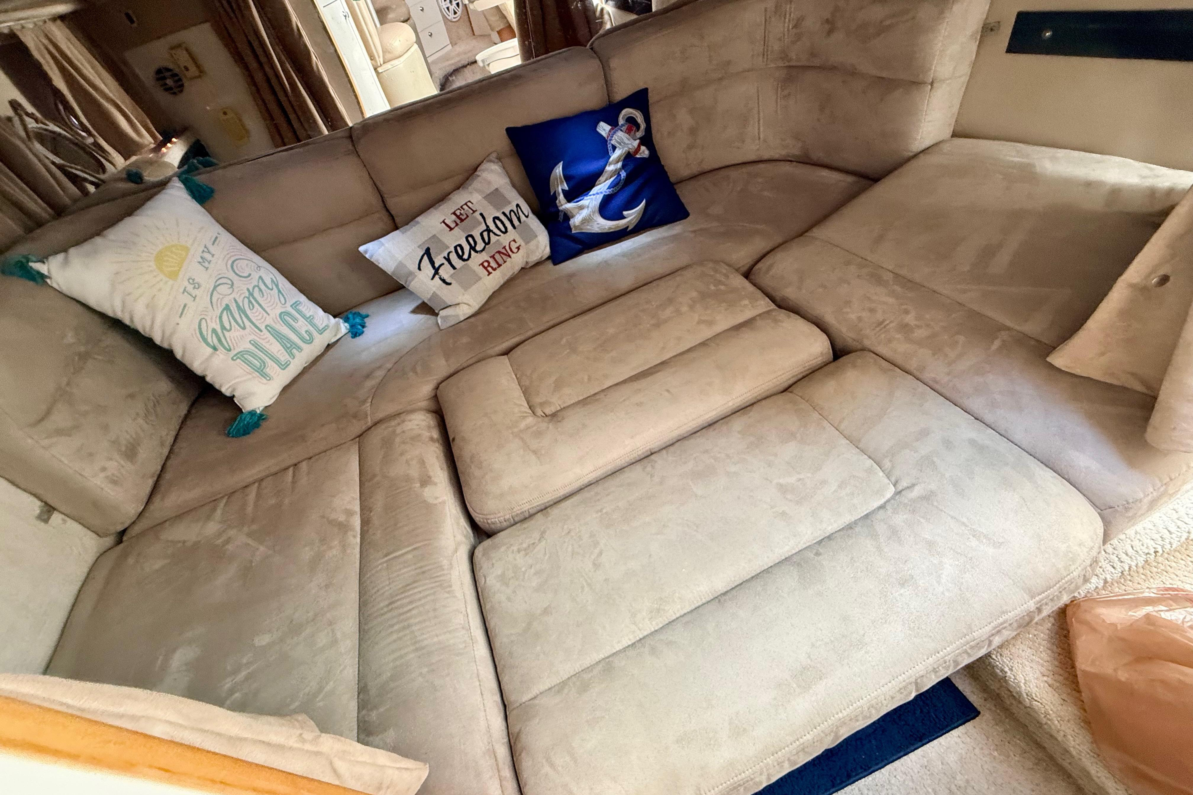 Interior of 1999 Chaparral Signature 300 with cozy seating and decorative pillows.