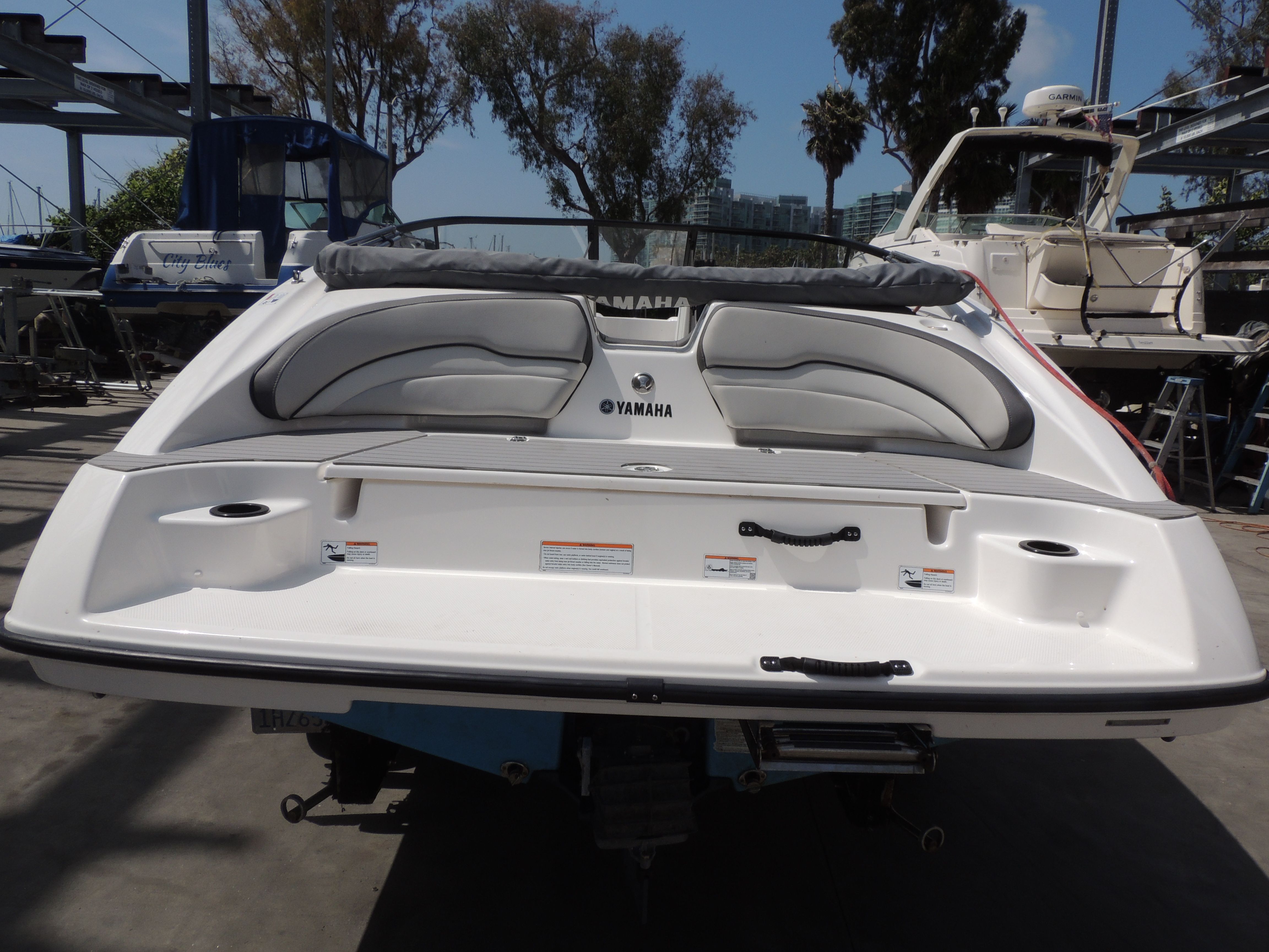Rear view of a 2023 Yamaha SX190 boat at the marina.