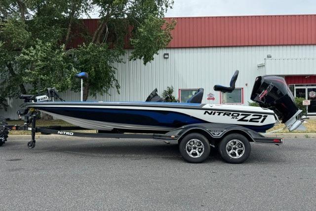 2026 Nitro Z21 XL boat on trailer, parked outdoors near a building.