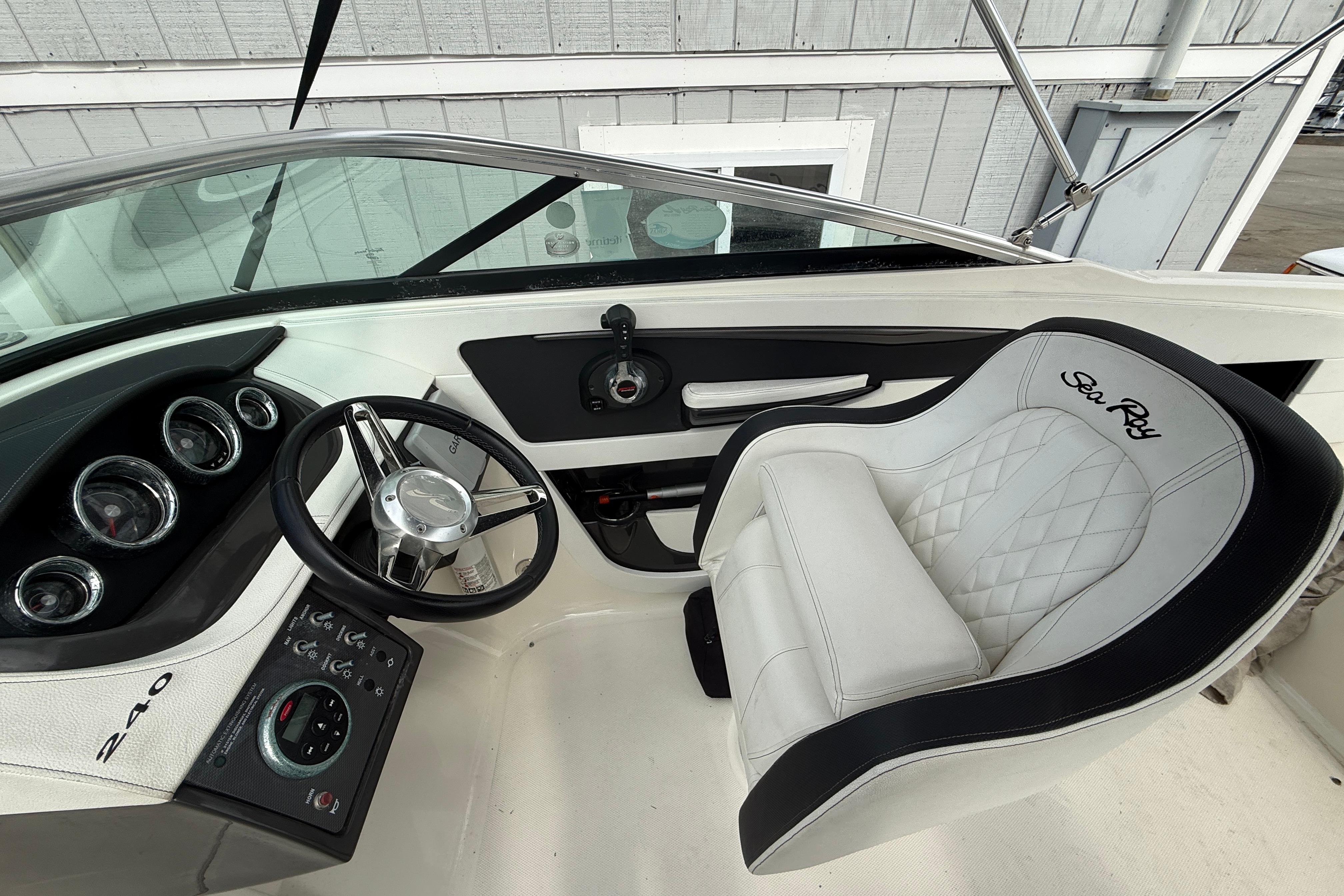 2015 Sea Ray 240 Sundeck cockpit with steering wheel and luxurious seating.