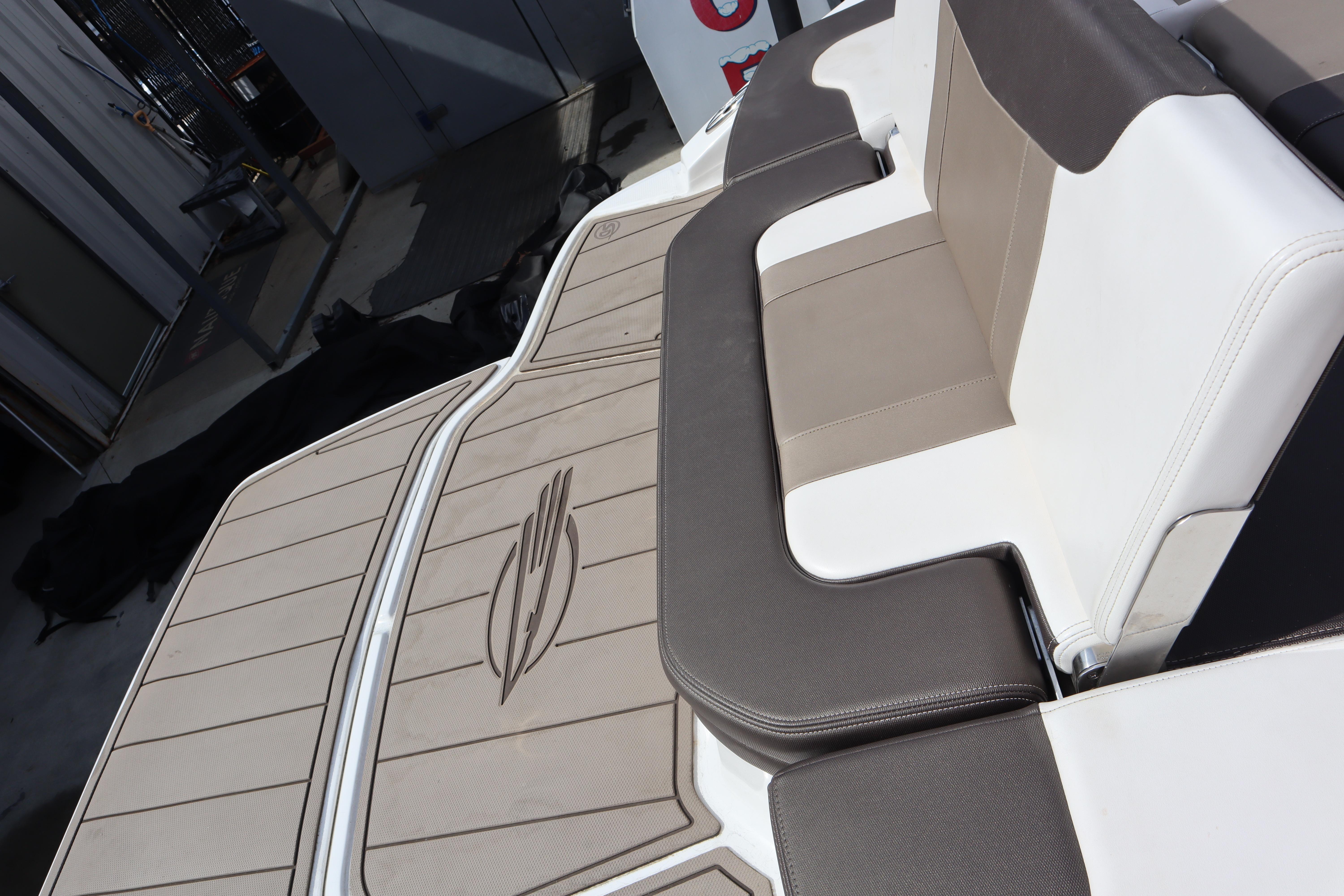 2021 Chaparral 21 SSi boat interior with beige and white seating.