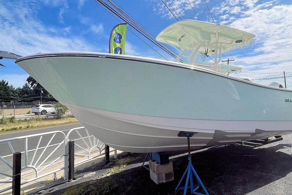 2023 Sea Born SX239 Offshore boat displayed outdoors under a clear blue sky.