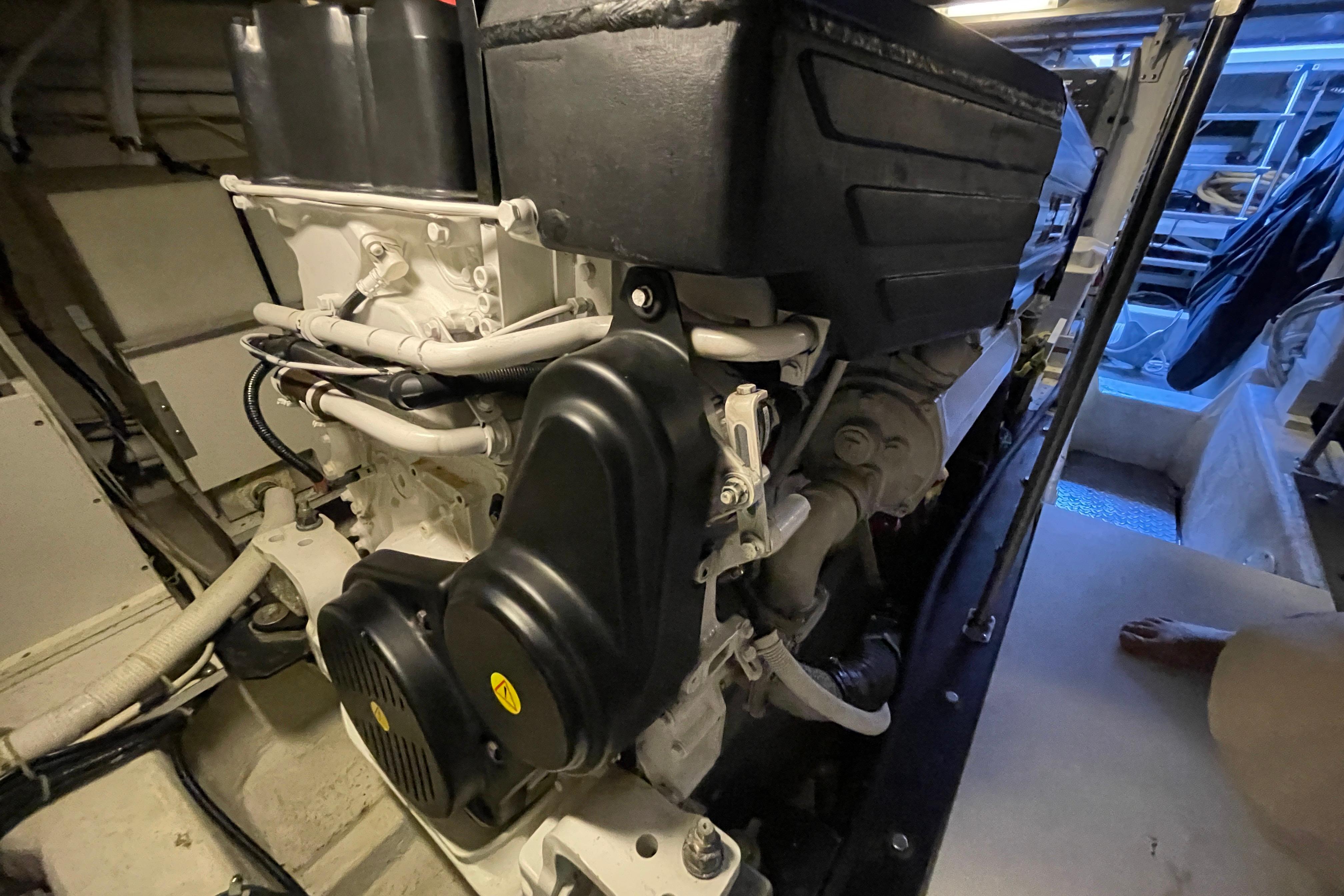 Engine room of 2002 Carver 570 Voyager Pilothouse, showcasing mechanical components.
