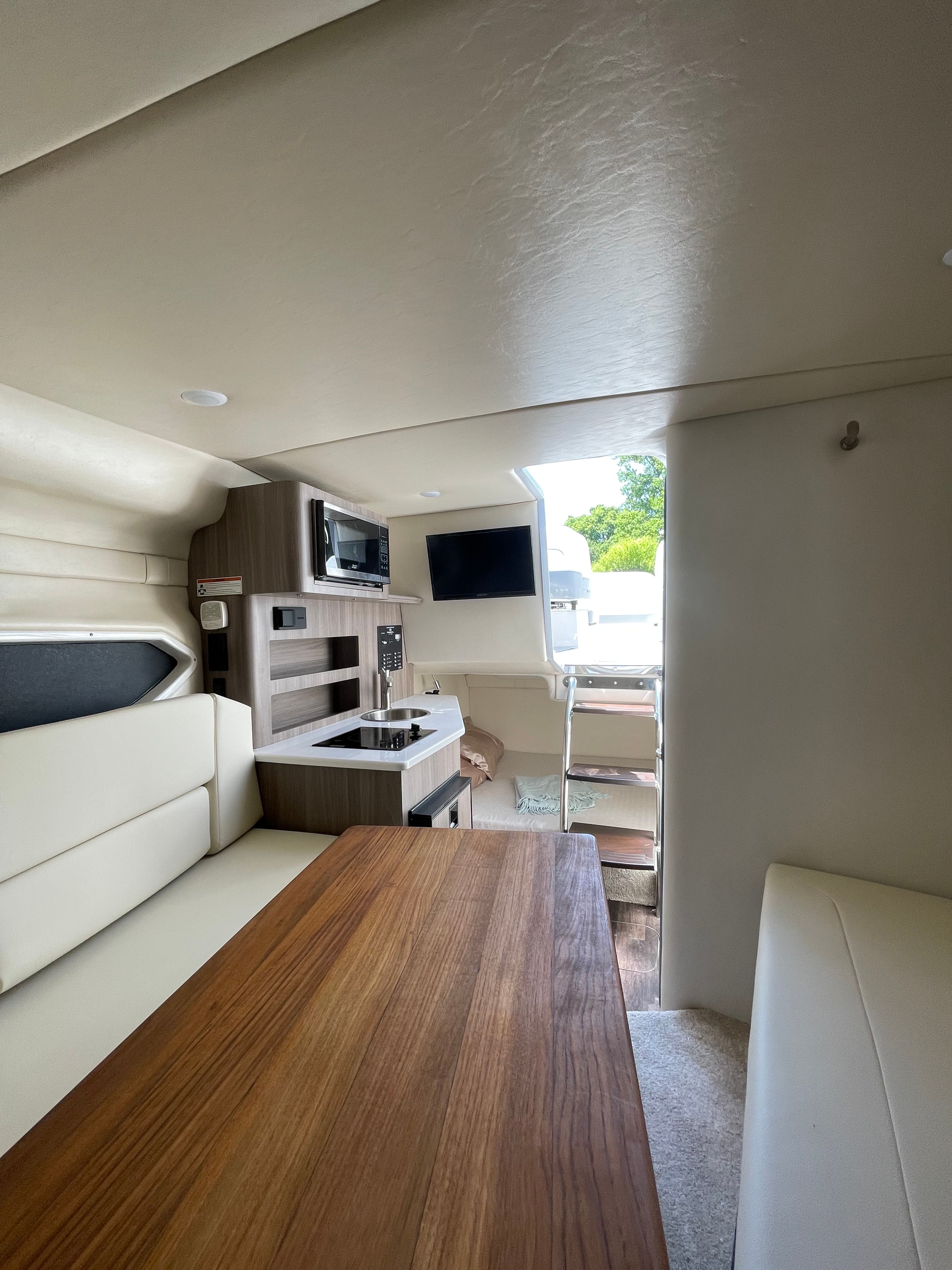 Interior of 2022 Regal 26 Express with kitchen and seating area.