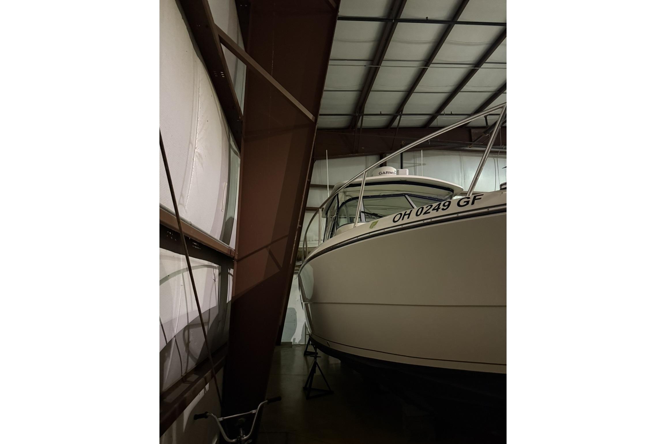 2000 Pursuit 3070 Offshore Center Console boat stored indoors.
